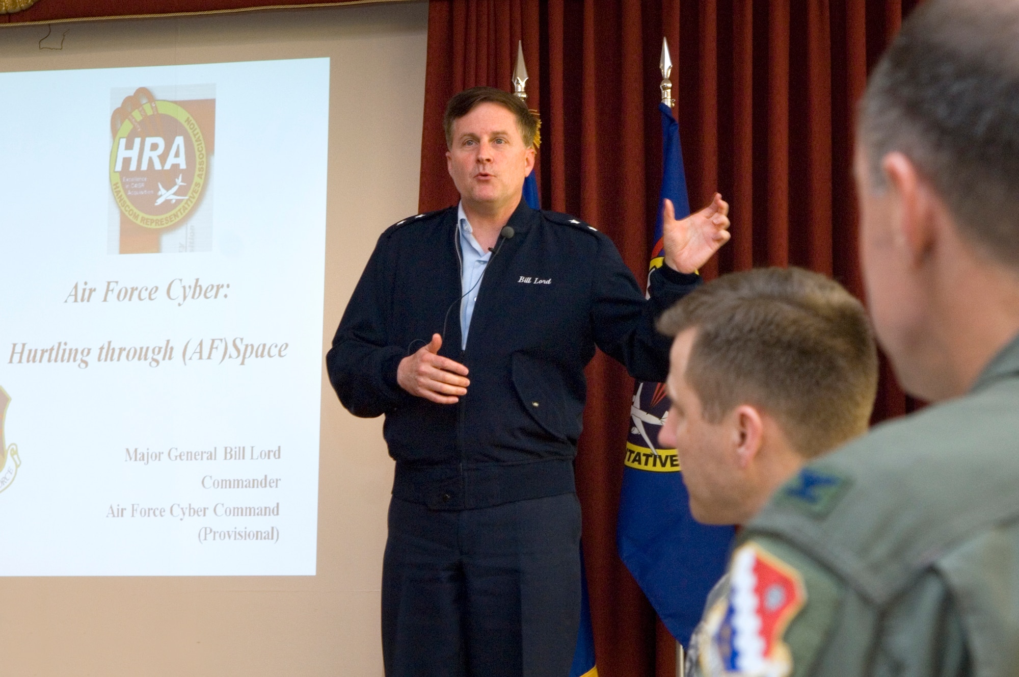 HANSCOM AIR FORCE BASE, Mass. -- Maj. Gen. William Lord, commander of the Air Force’s (Provisional) Cyber Command, addresses attendees at the Hanscom Representatives Association meeting in the Minuteman Club May 8.  Col. Joseph Pridotkas (center), AFCYBER-P’s liaison to the Electronic Systems Center, and 66th Air Base Wing Commander Col. Dave ‘Iron’ Orr, were among those in attendance.  (USAF Photo by Mark Wyatt)