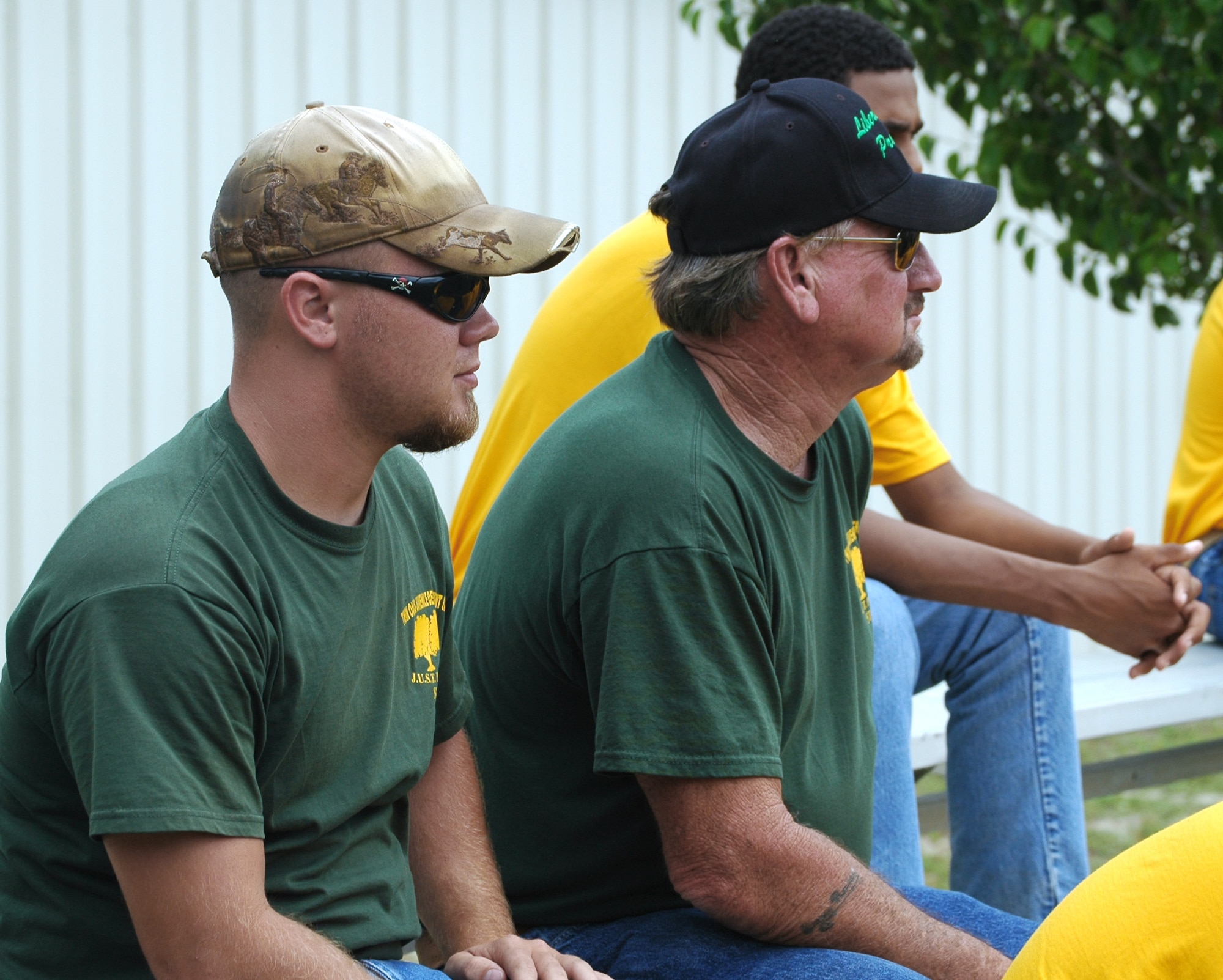 Ray Lasseter (left) and Ernest Rayley watch as members of the 325th Security Forces Squadron K-9 unit showcase one of the military working dog's skills May 5 at Tyndall Air Force Base, Fla. The two men escorted a group of 10 teenagers involved with their program who were chosen to tour the base due to their consistent good behavior through the boys' rehabilitation. Mr. Lasseter and Mr. Rayley are Liberty Juvenile Unit for Specialized Treatment team leaders. (U.S. Air Force photo/Staff Sgt. Joshua Stevens) 
