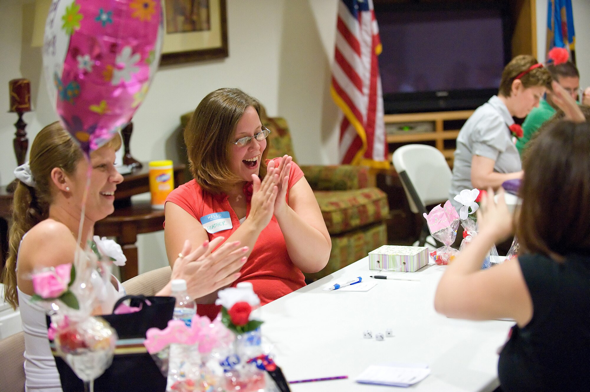 (Left) Ashley Kennedy, wife of Staff Sgt. Mark Kennedy, 436th Operations Support Squadron; and Heather Cameron, wife of Senior Airman Theodore Cameron, 436th Force Support Squadron, celebrate during a game of Bunko Bingo at the Pinnacle Housing Community Center May 8.  The event was held to honor Military Spouse Appreciation Day.  (U.S. Air Force photo/Jason Minto)