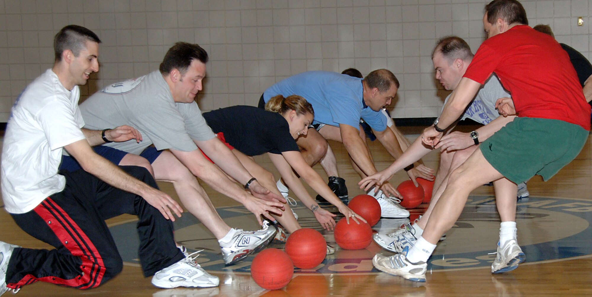 Members of the 18th Air Refueling Squadron race to midcourt at the start of a dodge ball game during the squadron's drill weekend in April. Leaders of the 18th ARS and other units within the 931st Air Refueling Group were encouraged to schedule events during the weekend to build teamwork and boost morale. The 931st ARG is an Air Force Reserve unit at McConnell Air Force Base, Kan. (U.S. Air Force photo/Senior Airman Connor Burkhard)