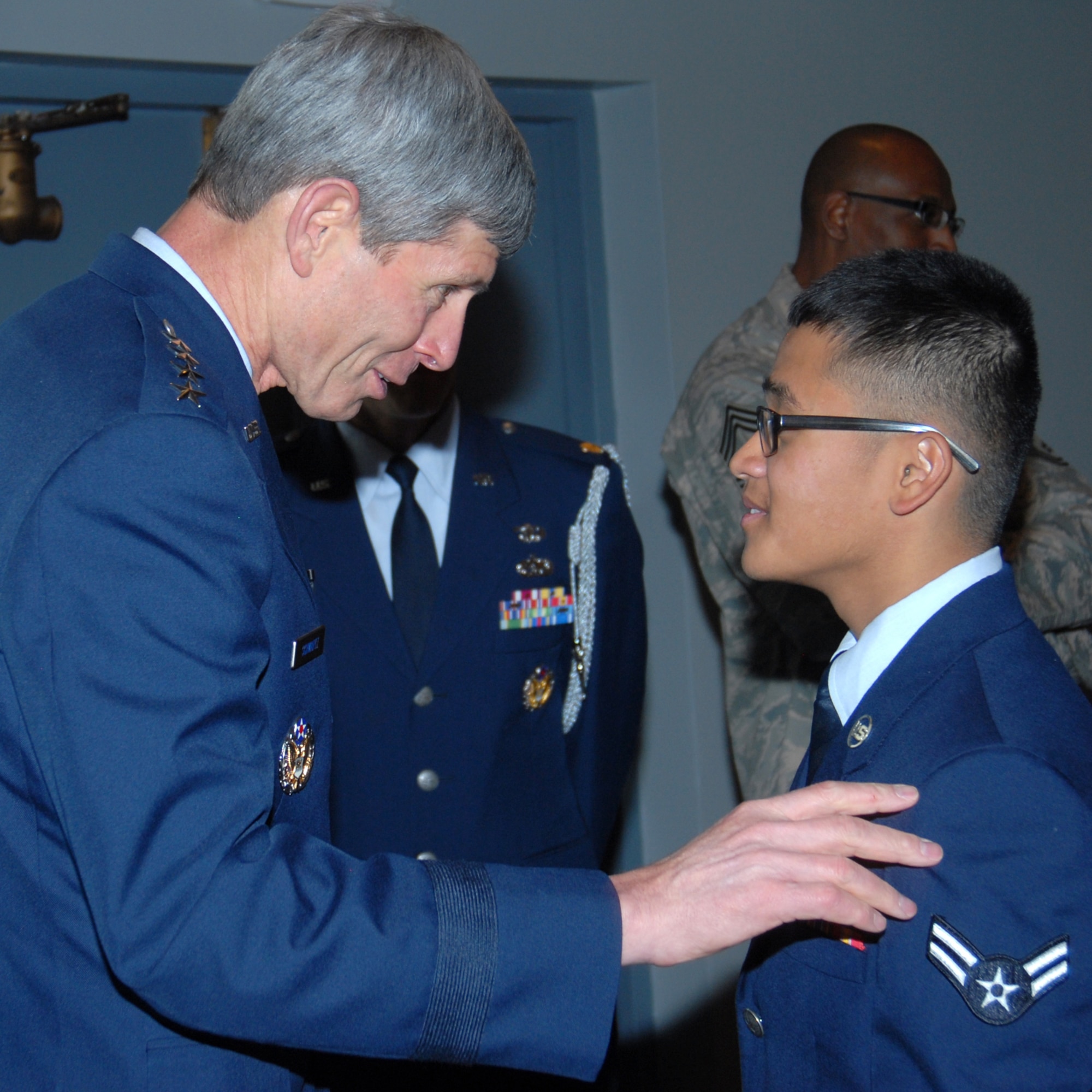 Air Force Chief of Staff Gen. Norton A. Schwartz talks with Airman 1st Class Jeremiles Vesey, 90th Logistics Readiness Squadron, during Chief Master Sgt. Al Martinez’ retirement ceremony in the Pronghorn Center Wednesday. Airman Vesey is the youngest Airman at Warren, and he presented Chief Martinez with a retirement coin. (Photo by Berni Ernst)