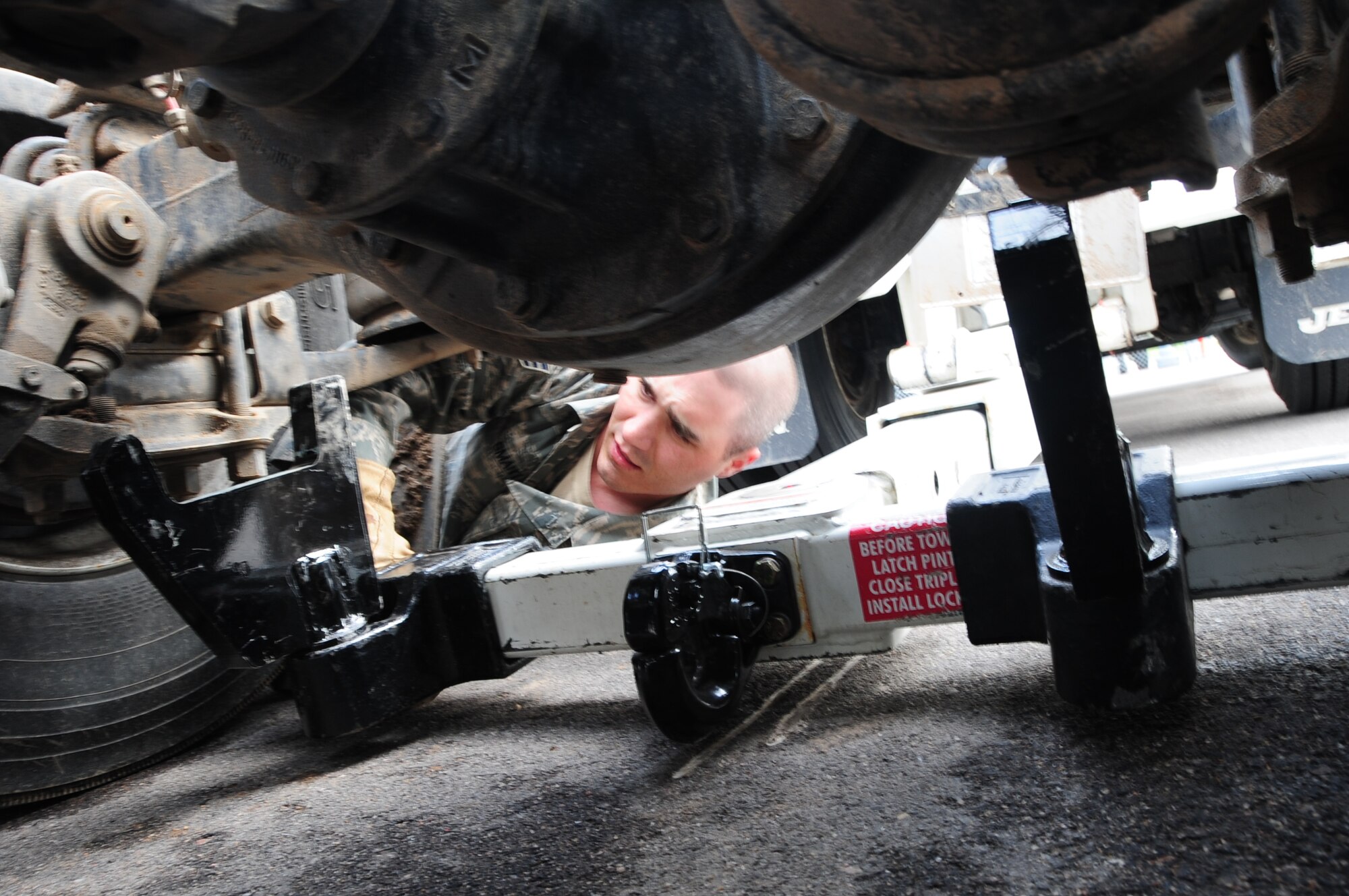 Senior Airman Thomas Smart, 28th Logistics Readiness Squadron vehicle operator, checks the position of the hydraulic under lift on a 5-ton wrecker to slide it under a vehicle for towing.  Proper positioning ensures safety when lifting vehicles. (U.S. Air Force photo/Senior Airman Anthony Sanchelli)