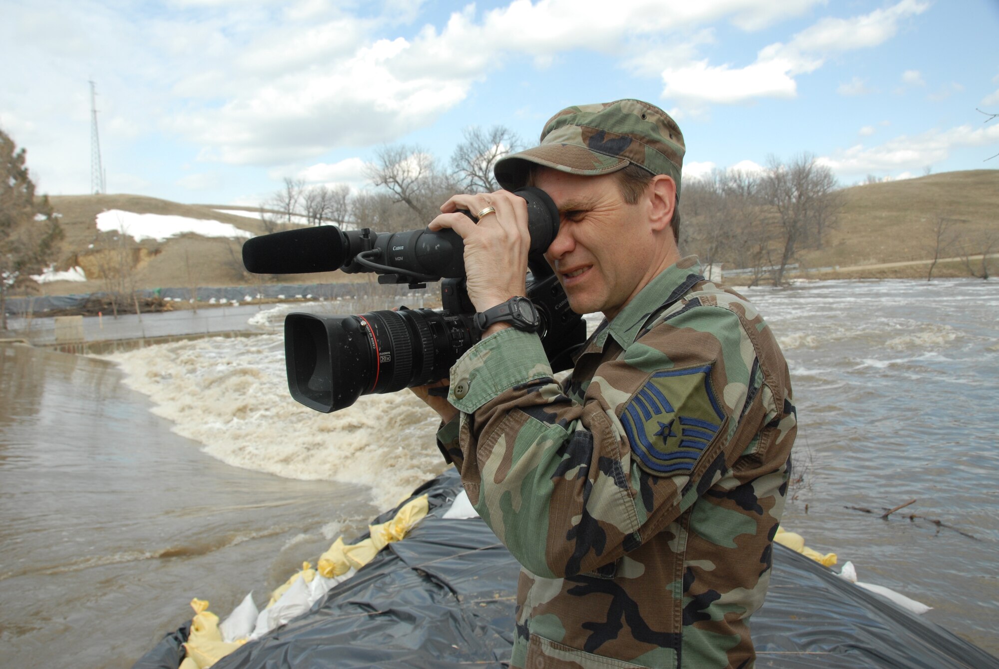 Master Sgt. Eric Johnson, of the 119th Wing, shoots video footage of flood waters in the Red River Valley March 29.