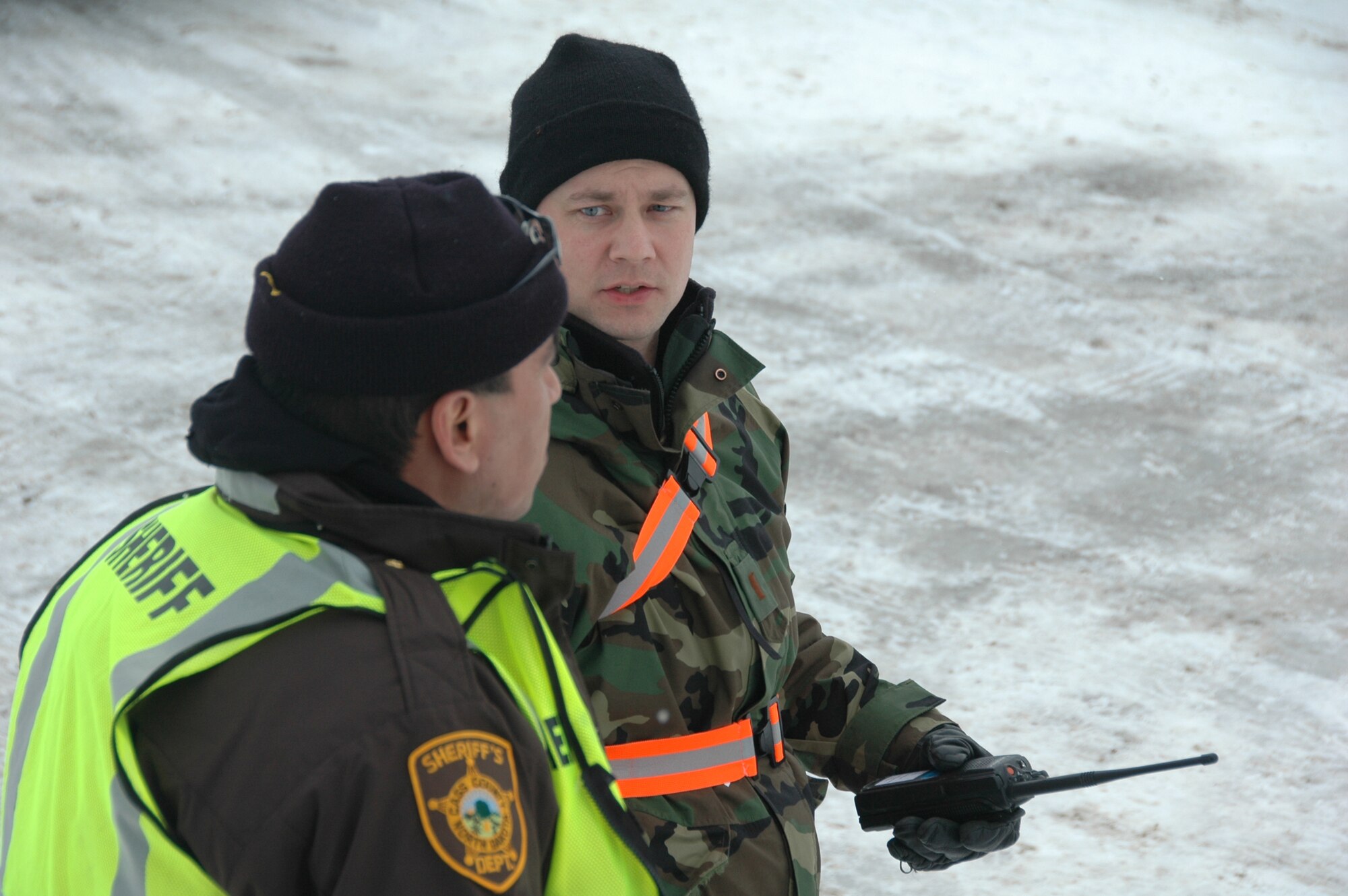 2nd Lt. Jeffery Hovdeness, of the 119th Wing, leads a quick response force team as he discusses plans for civilian welfare visits in rural areas north of Fargo with a Cass County Sherrif's deputy April 1.