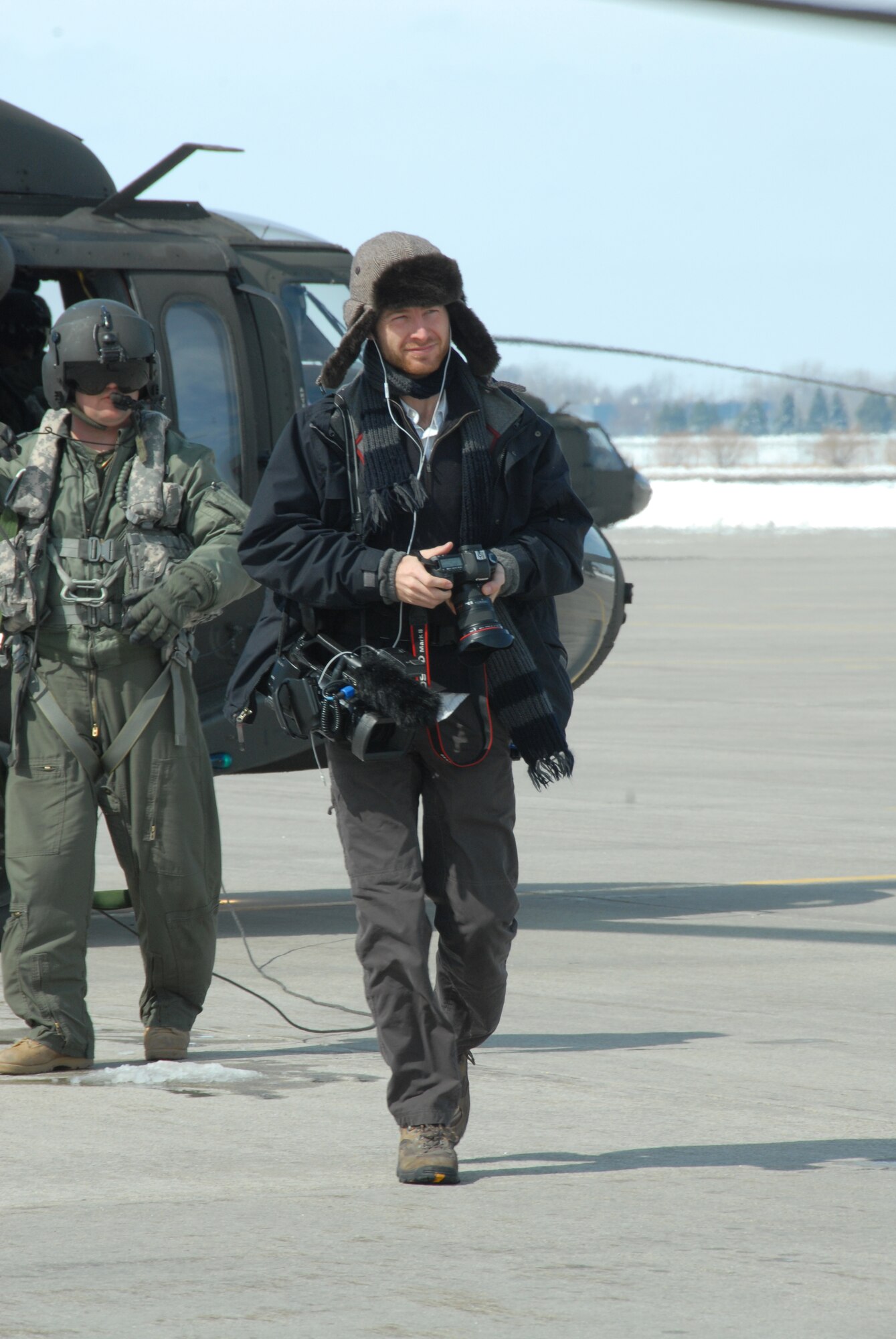 Garrett Hubbard, of USA Today, departs from a North Dakota National Guard Black Hawk Helicopter after taking photos on a media flight on March 28.  Hubbard was in Fargo to document the flood efforts in the Red River Valley of North Dakota this spring.