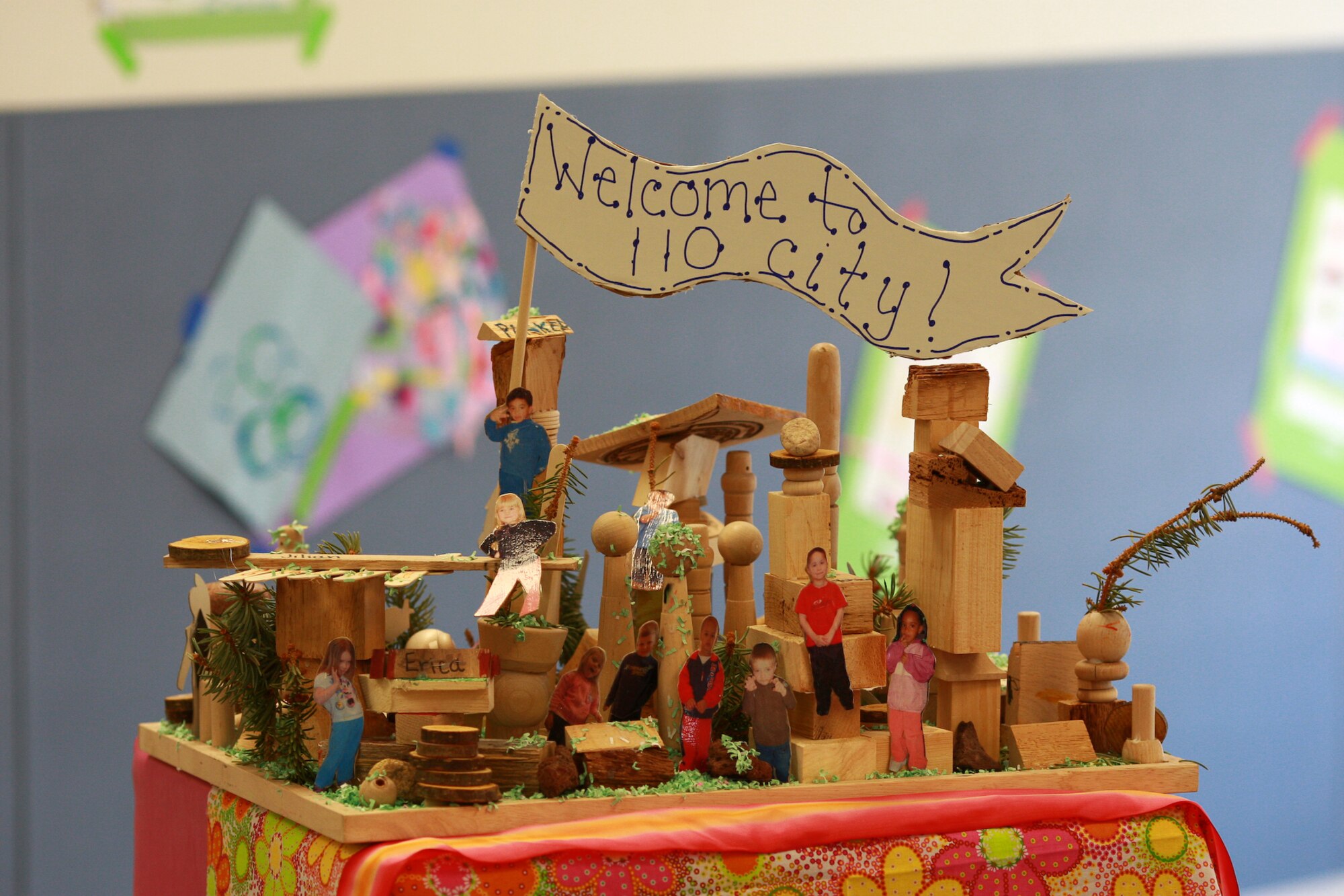 Children from preschool class 110 created a wooden collage display during the child development center's art show April 22. The piece of art shows the children from that class in a variety of poses playing on the wooden playground. (Photo by Jeff Allred)