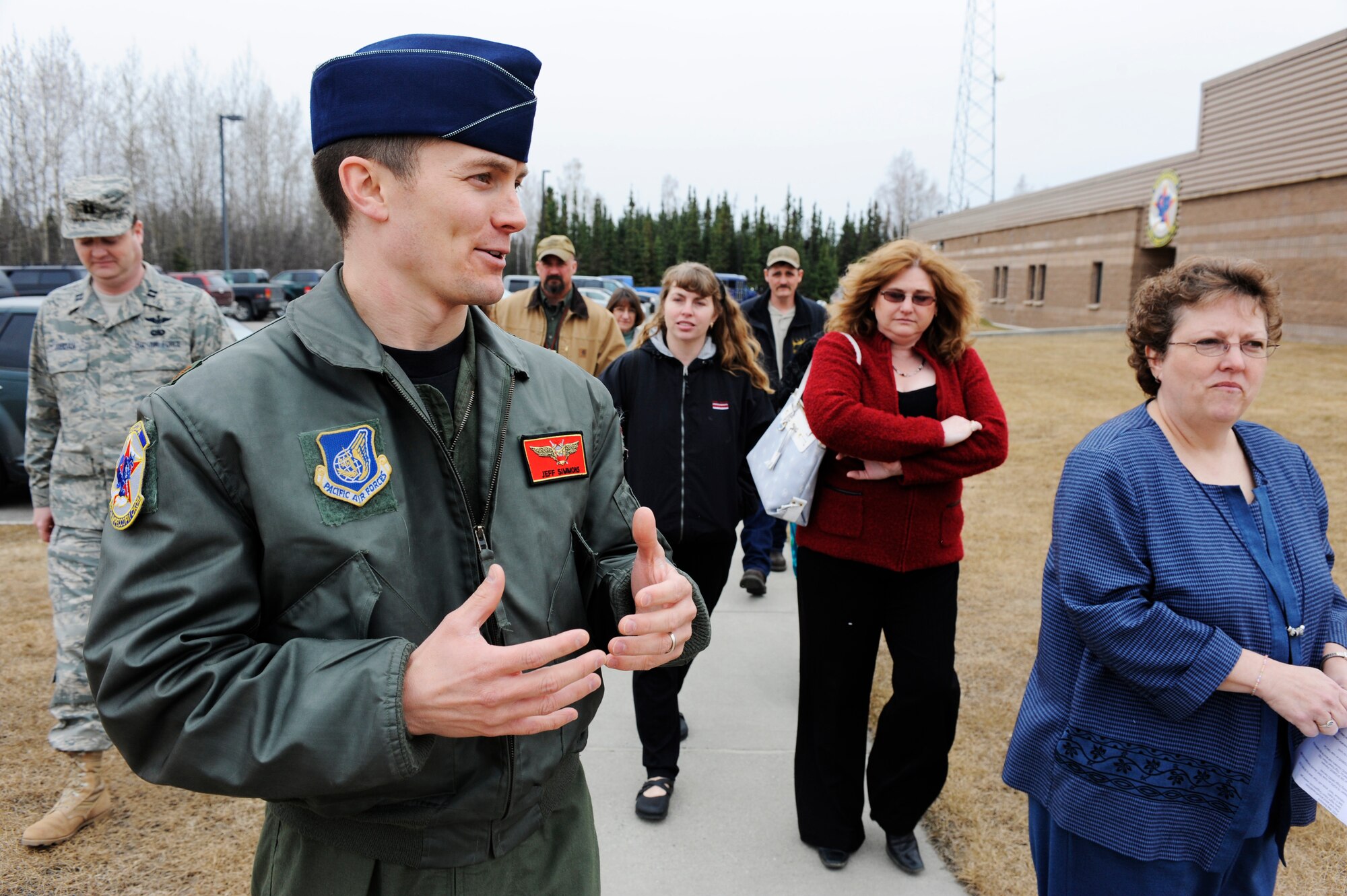 Maj. Jeff Simmons, 18th Aggressor Squadron pilot, escorts local teachers around the 18th Aggressor Squadron May 6, 2009, Eielson Air Force Base, Alaska. Seven local teachers were selected to be recognized by the Eielson community for their dedication on educating Military children.  (U.S. Air Force Photo/Senior Airman Jonathan Snyder)