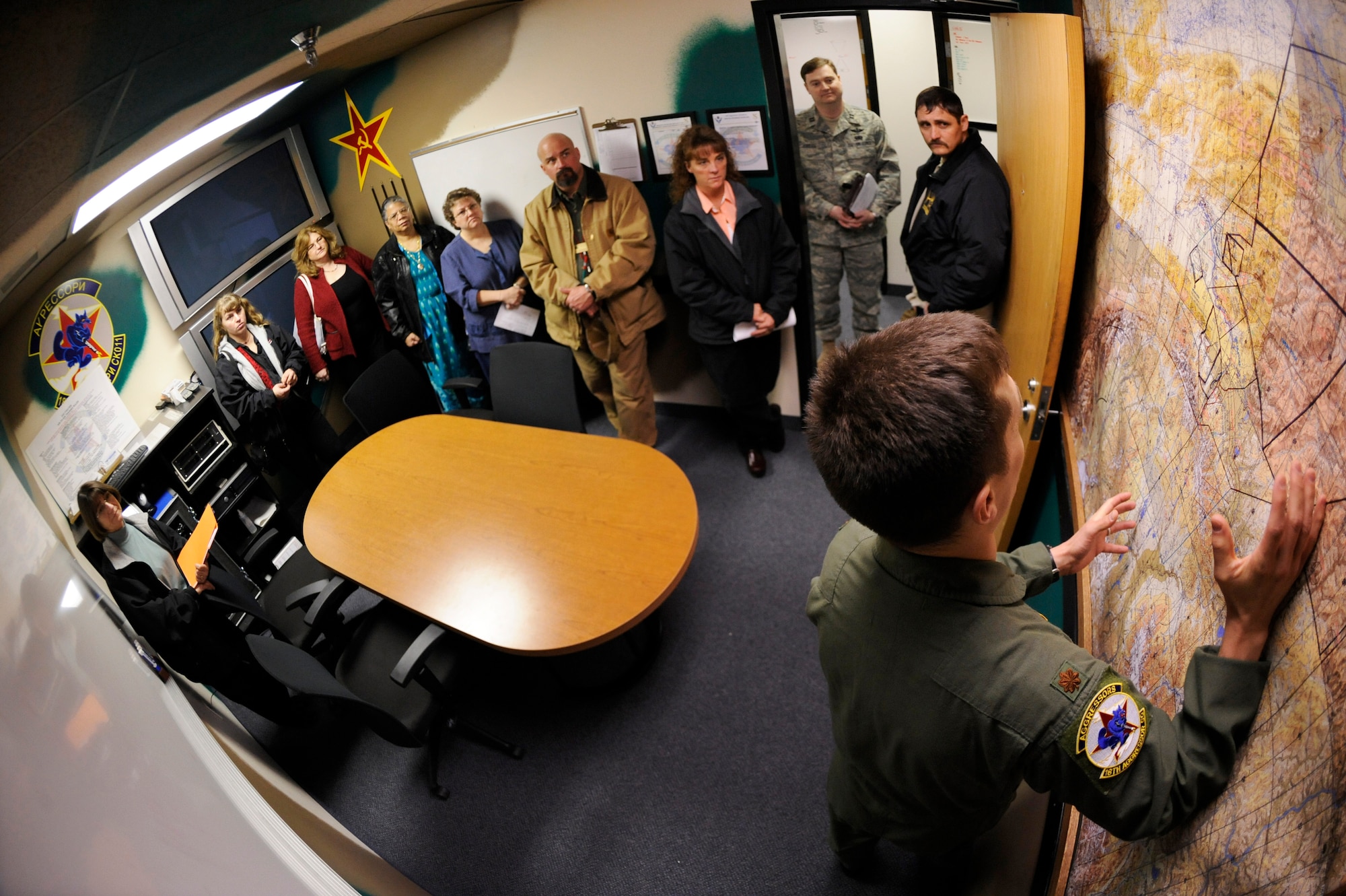Maj. Jeff Simmons, 18th Aggressor Squadron pilot, explains the advantages of the Joint Pacific Alaskan Range Complex for training capabilities it provides for participants May 6, 2009, Eielson Air Force Base, Alaska. Seven local teachers were selected to be recognized by the Eielson community for their dedication and positive impact on educating Military children.  (U.S. Air Force Photo/Senior Airman Jonathan Snyder)