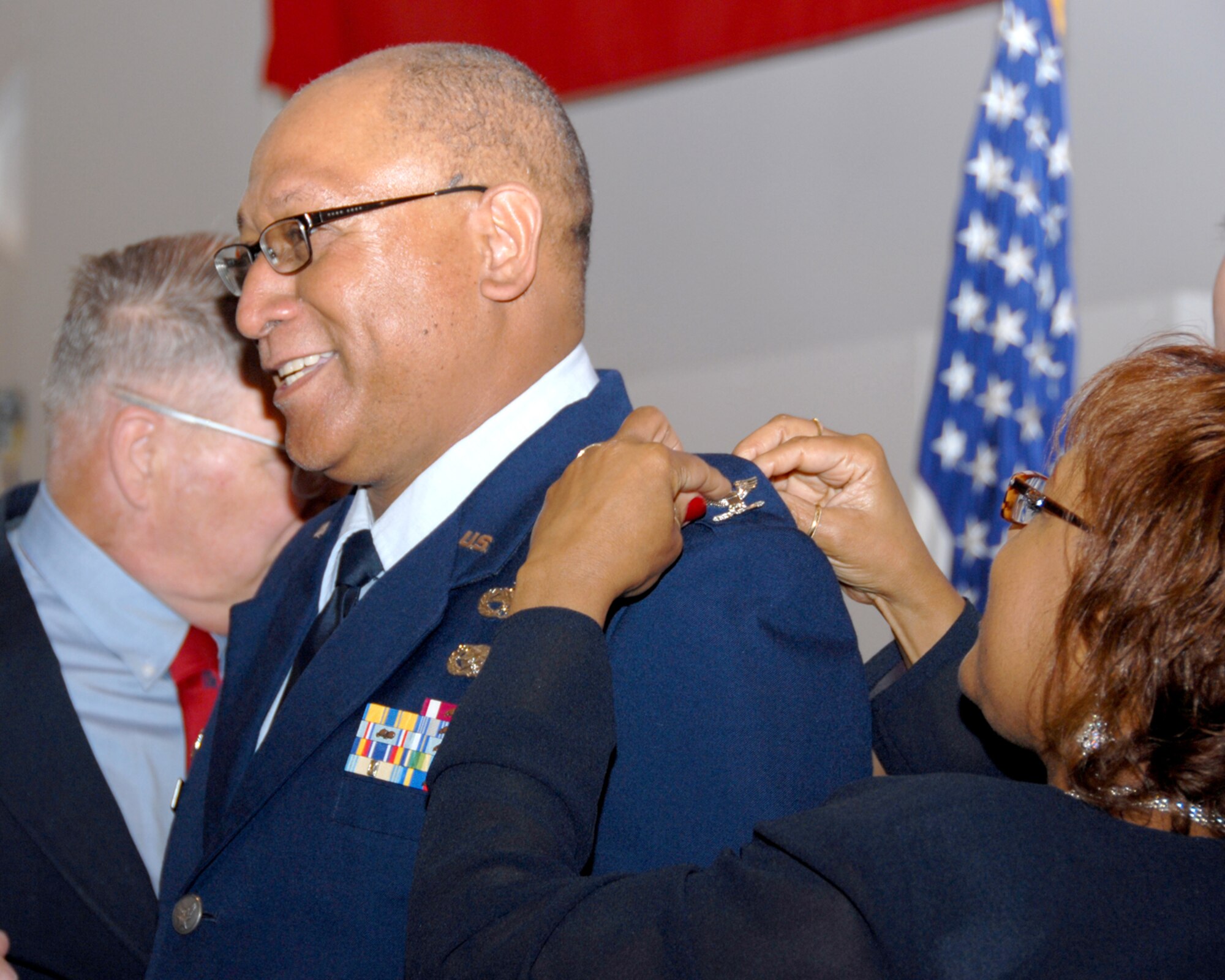 Shirley McDaniel pins a colonel eagle insignia on newly promoted Col. Ron McDaniel's service dress jacket May 2 at a 2 p.m. Little Rock Air Force Base ceremony. The colonel is the first African-American in the Arkansas Air National Guard's 189th Airlift Wing to be promoted to the rank of colonel, and he's the second African-American in the state to have worn colonel's eagles. The first was Col. James Abernathy, who is retired. (Photo by Master Sgt. Dianna Seerey)