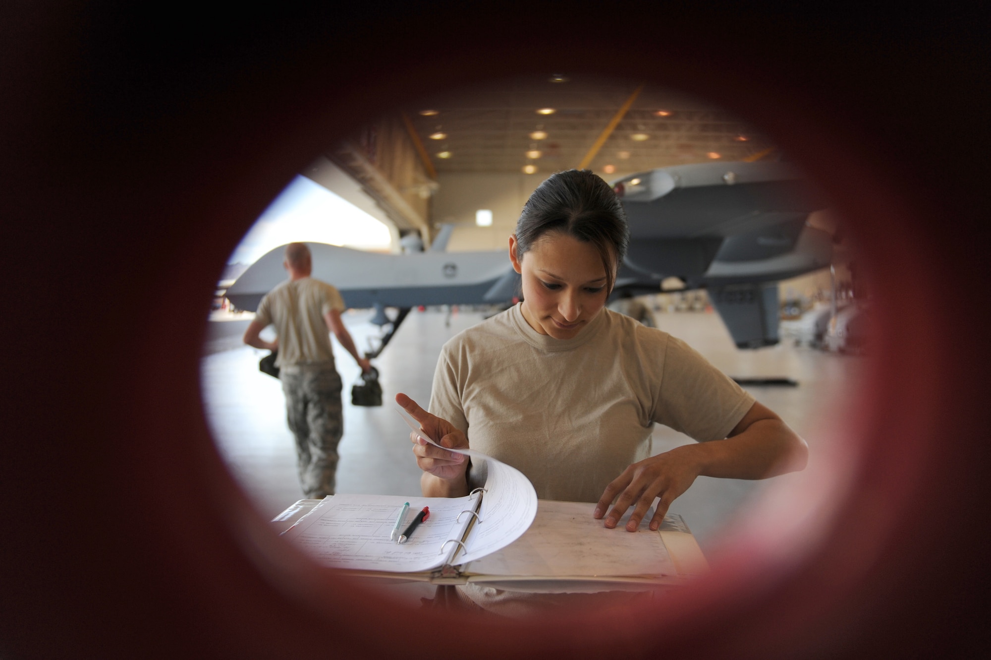 Staff Sgt. Stephanie Hughes reviews loading procedures during weapons load training April 22 at Creech Air Force Base, Nev. MQ-9 Reaper load crewmembers were conducting monthly training to maintain their qualifications on the airframe. Sergeant Hughes is a Reaper load crew team chief assigned to the 432nd Aircraft Maintenance Squadron. (U.S. Air Force photo/Senior Airman Larry E. Reid Jr.) 
