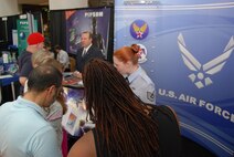 ALEXANDRIA, Va. - Mr. Richard Osburn and Tech. Sgt. Jennifer Buzanowski, Air Force Public Affairs Agency, talk to visitors of the U.S. Patent and Trademark Office's 2009 Expo May 9. The Air Force Trademark and Licensing Office was the first military branch to attend the USPTO's annual expo that drew a crowd of 7,000 people for the two-day event. The U.S. Air Force Band performed during the opening ceremony May 8. (U.S. Air Force Photo/Jessica O'Haver)