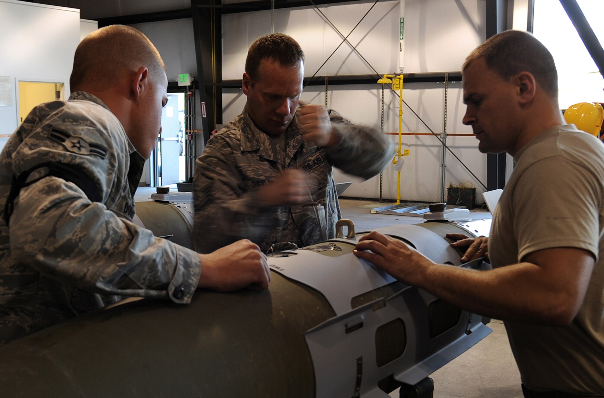 Airman 1st Class Justin Dodds, Master Sgt. Stacyjoe Davlin and Staff Sgt. Travis Pace, 49th Aircraft Maintenance Squadron, build a bomb for the F-22A Raptor during the Combat Hammer exercise at Hill Air Force Base, Utah. Combat Hammer is a weapons testing program that is apart of the Air Force's effort to test weapons systems to prepare air crews for upcoming deployments in training missions. (U.S. Air Force photo by Senior Airman Michael Means)