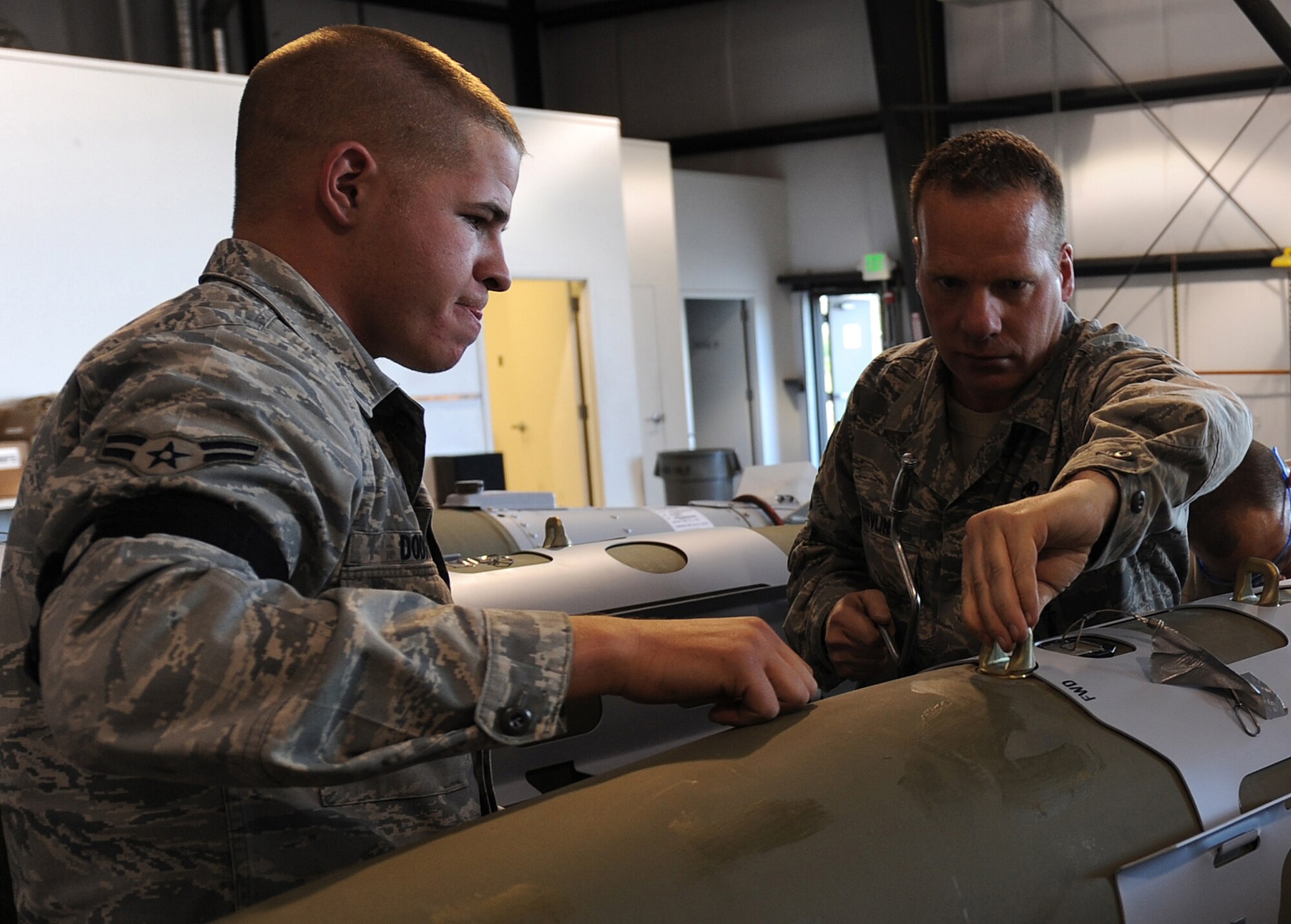 Airman 1st Class Justin Dodds and Master Sgt. Stacyjoe Davlin, 49th Aircraft Maintenance Squadron, build a bomb for the F-22A Raptor during the Combat Hammer exercise at Hill Air Force Base, Utah. Combat Hammer is a weapons testing program that is apart of the Air Force's effort to test weapons systems to prepare air crews for upcoming deployments in training missions. (U.S. Air Force photo by Senior Airman Michael Means)
