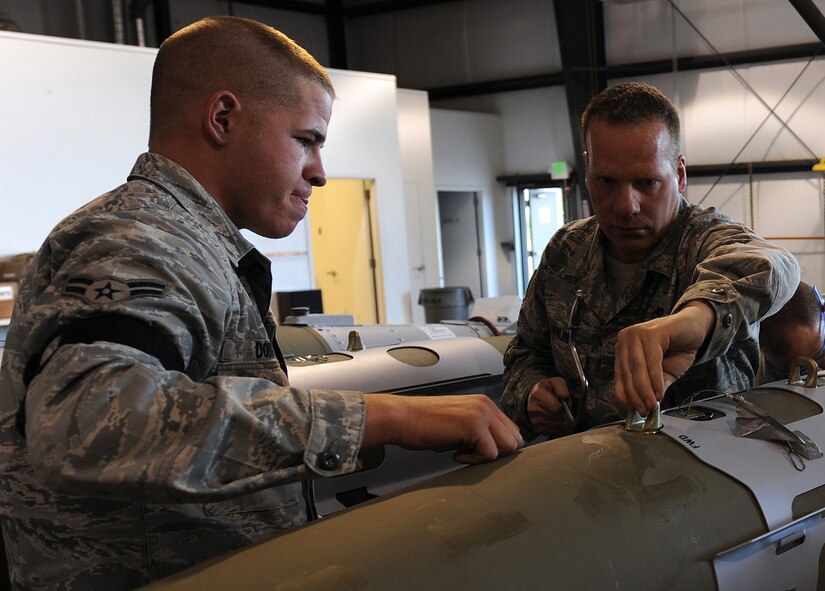 Airman 1st Class Justin Dodds and Master Sgt. Stacyjoe Davlin, 49th Aircraft Maintenance Squadron, build a bomb for the F-22A Raptor during the Combat Hammer exercise at Hill Air Force Base, Utah. Combat Hammer is a weapons testing program that is apart of the Air Force's effort to test weapons systems to prepare air crews for upcoming deployments in training missions. (U.S. Air Force photo by Senior Airman Michael Means)
