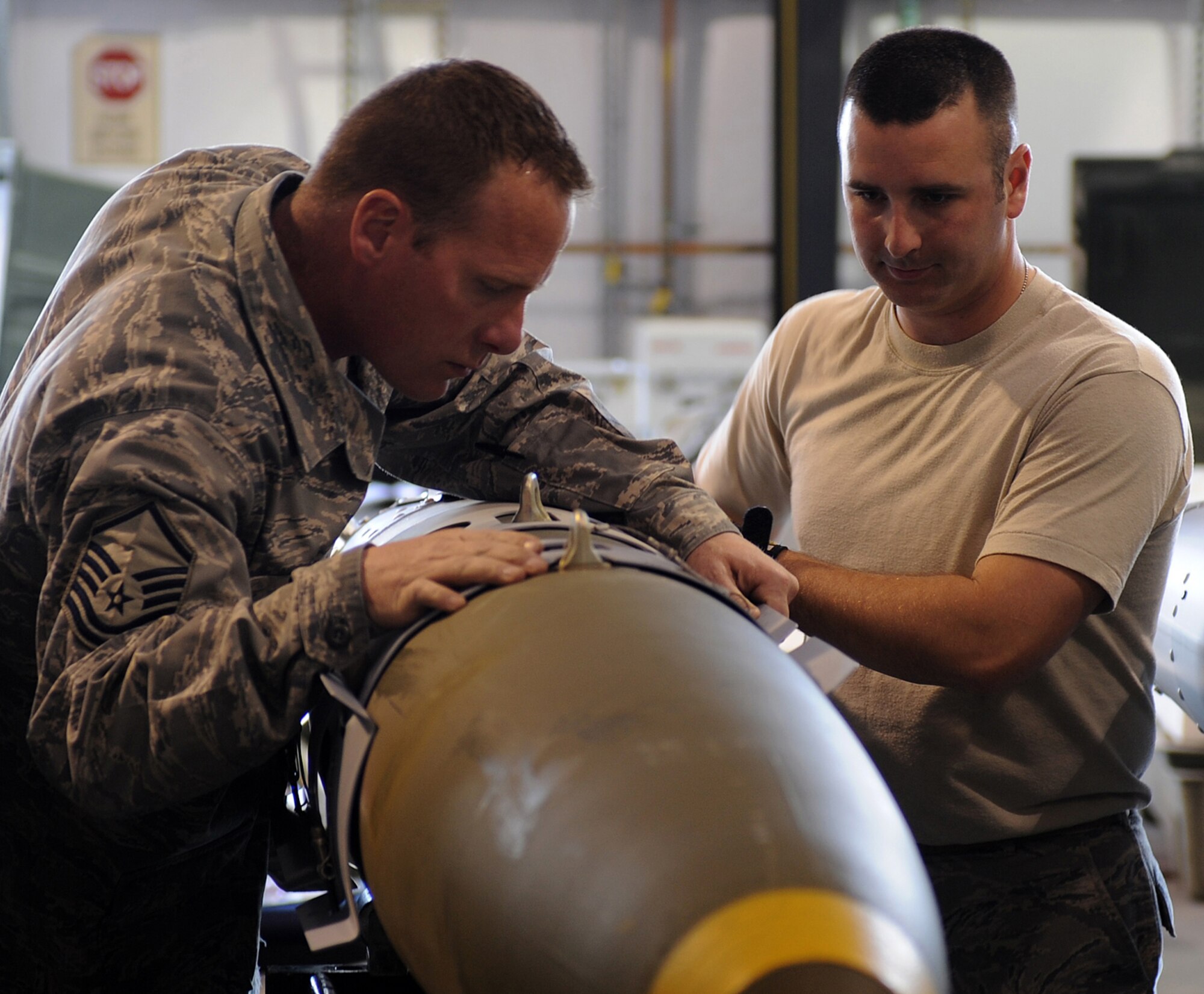 Master Sgt. Stacyjoe Davlin and Staff Sgt. Ryan Mutter, 49th Aircraft Maintenance Squadron, build a bomb for the F-22A Raptor during the Combat Hammer exercise at Hill Air Force Base, Utah. Combat Hammer is a weapons testing program that is apart of the Air Force's effort to test weapons systems to prepare air crews for upcoming deployments in training missions. (U.S. Air Force photo by Senior Airman Michael Means)