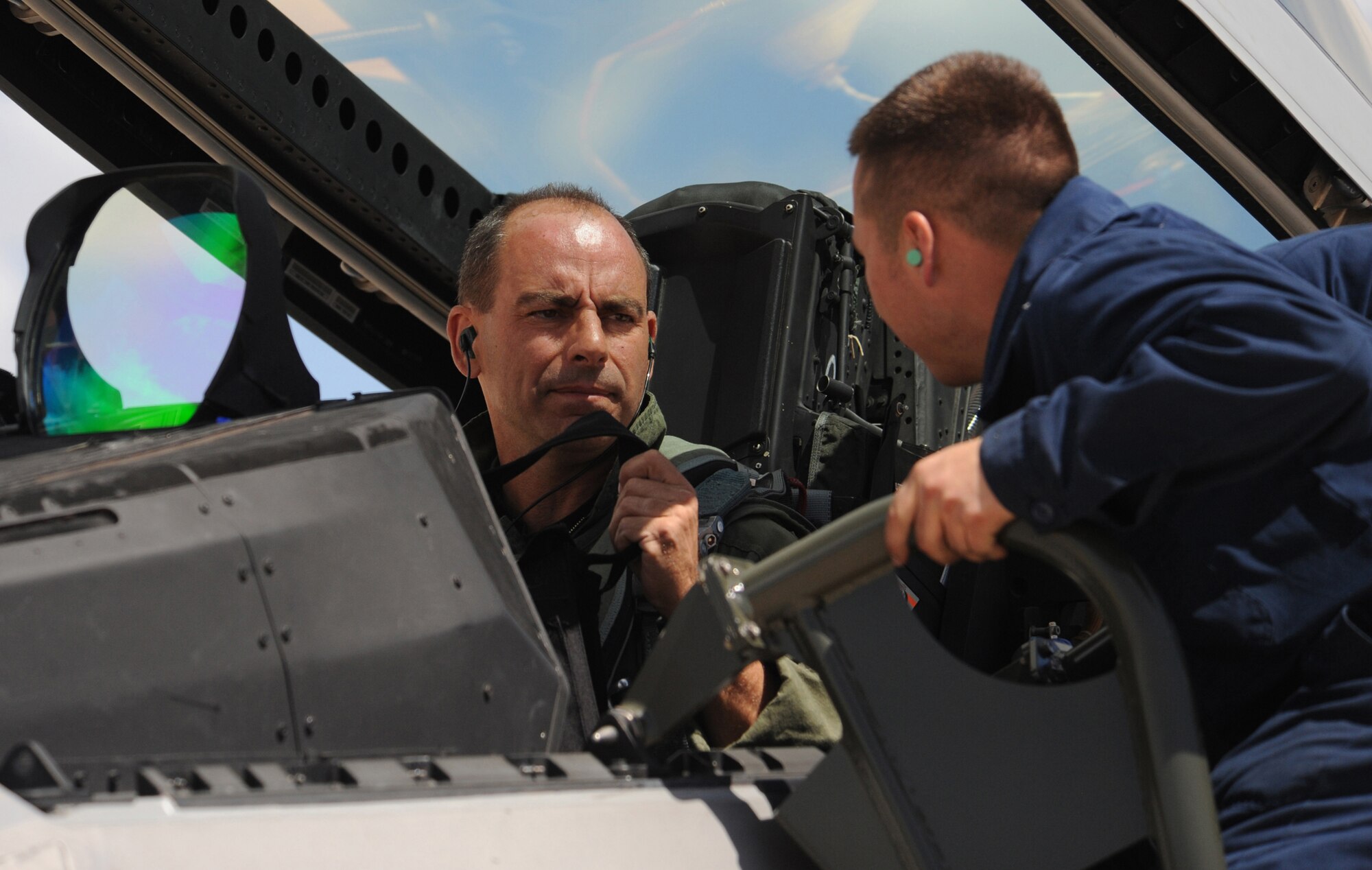 Col. Jeff Harrigian, 49th Fighter Wing commander, is assited by Senior Airman Mark Leger, 49th Aircraft Maintenance Squadron, before an F-22A Raptor aerial mission of the Combat Hammer exercise at Hill Air Force Base, Utah, May. 7. The F-22's at Holloman Air Force Base, N.M., came here on their first deployment. (U.S. Air Force Photo/ Senior Airman Michael Means)