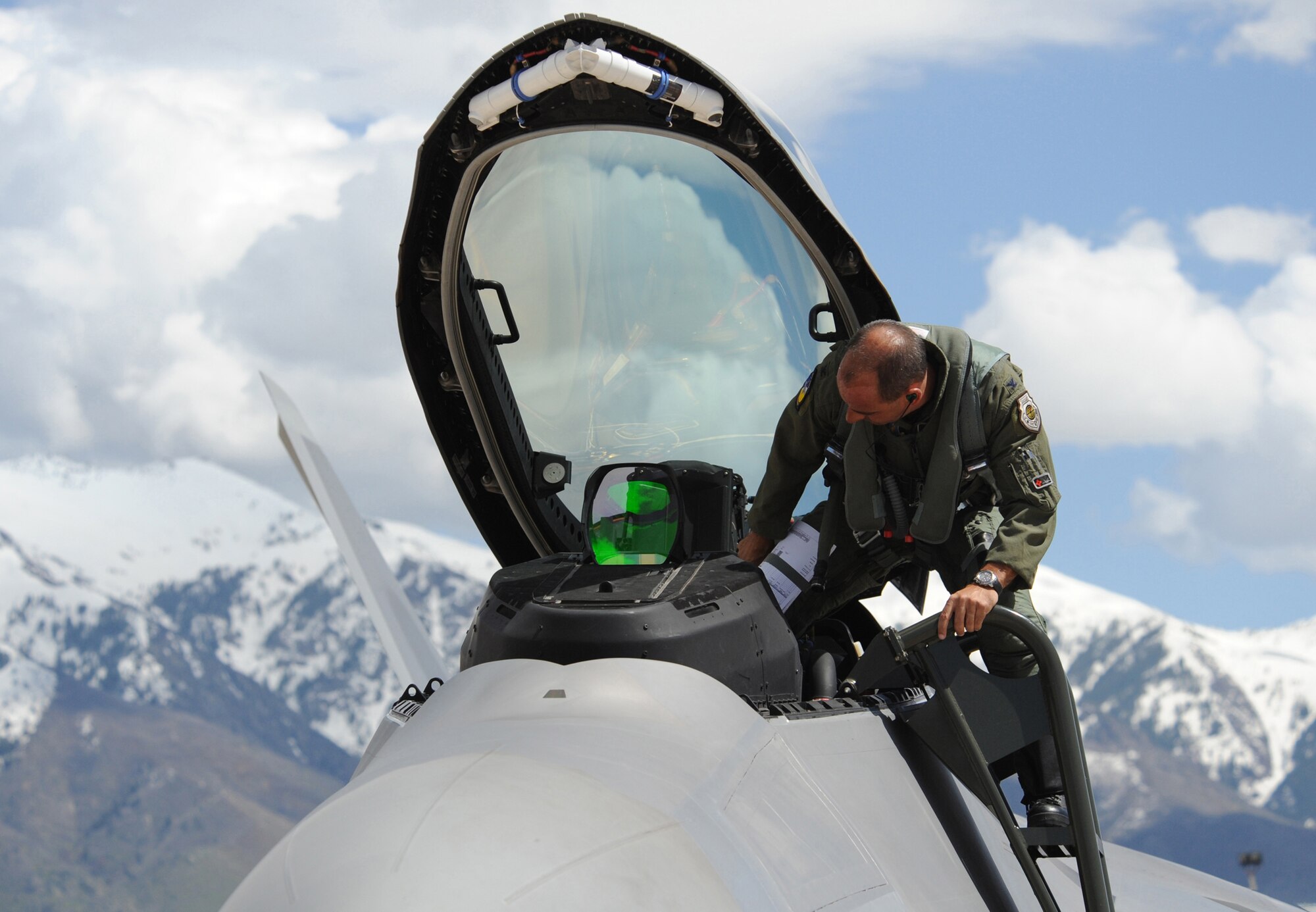 Col. Jeff Harrigian, 49th Fighter Wing commander, climbs into an F-22A Raptor before an aerial mission of the Combat Hammer exercise at Hill Air Force Base, Utah, May 7. The F-22's at Holloman Air Force Base, N.M., came here on their first deployment. (U.S. Air Force Photo/ Senior Airman Michael Means)