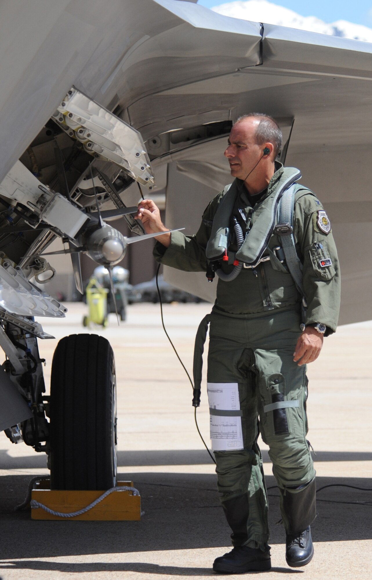 Col. Jeff Harrigian, 49th Fighter Wing commander, climbs into an F-22A Raptor before an aerial mission of the Combat Hammer exercise at Hill Air Force Base, Utah, May 7. The F-22's at Holloman Air Force Base, N.M., came here on their first deployment. (U.S. Air Force Photo/ Senior Airman Michael Means)