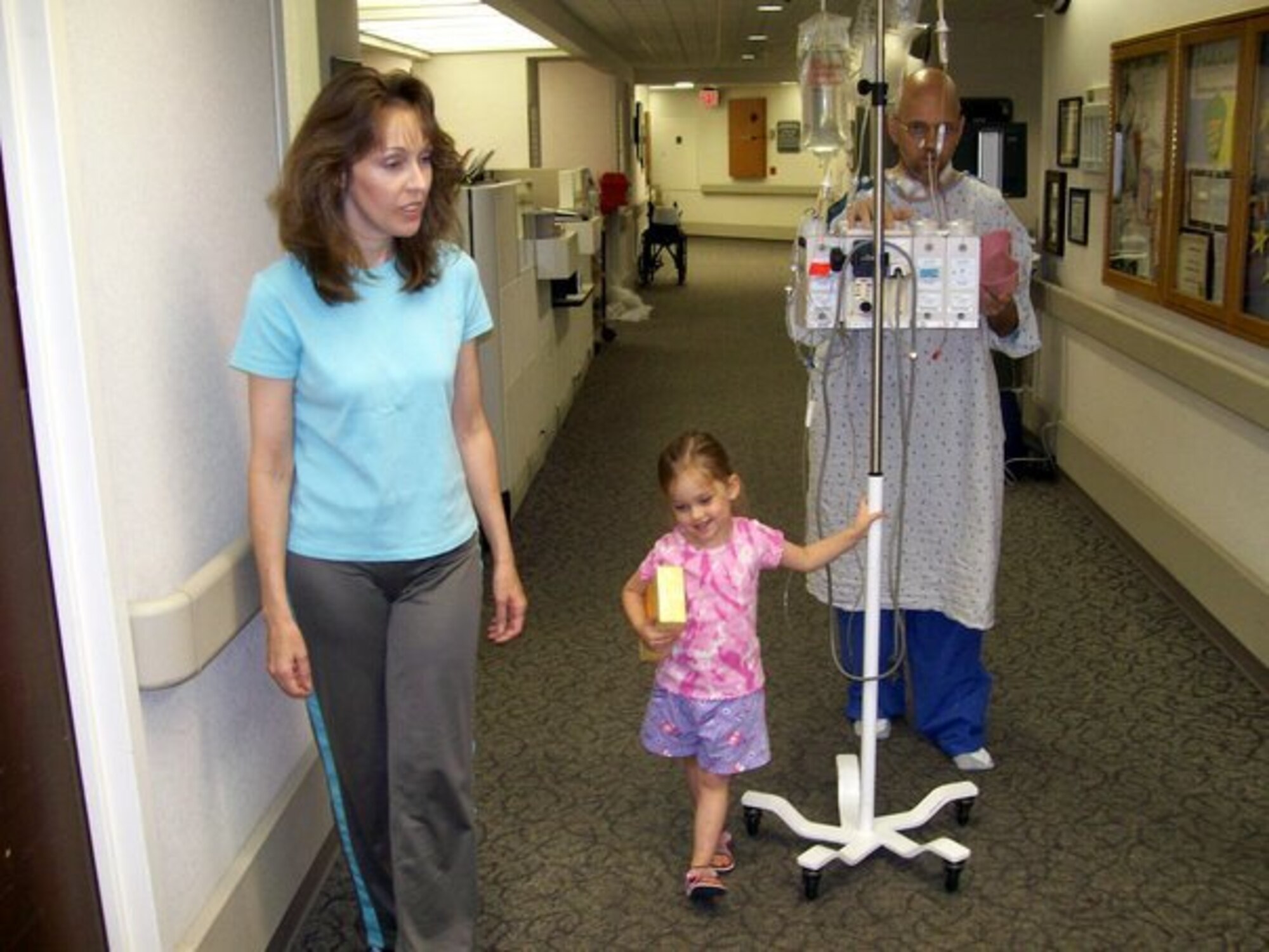 Master Sgt. Mike Sanders takes his first walk after undergoing surgery to remove stage IV cancer from his neck and throat in 2007.  The tumor that doctors removed from his neck was the size of a racquetball and eating was impossible right away. “The cliché ‘you never know what you’ve got until it’s gone’ is so true,” said Sergeant Sanders. “Being able to taste food is one of those things.” (Photo courtesy Master Sgt. Mike Sanders)