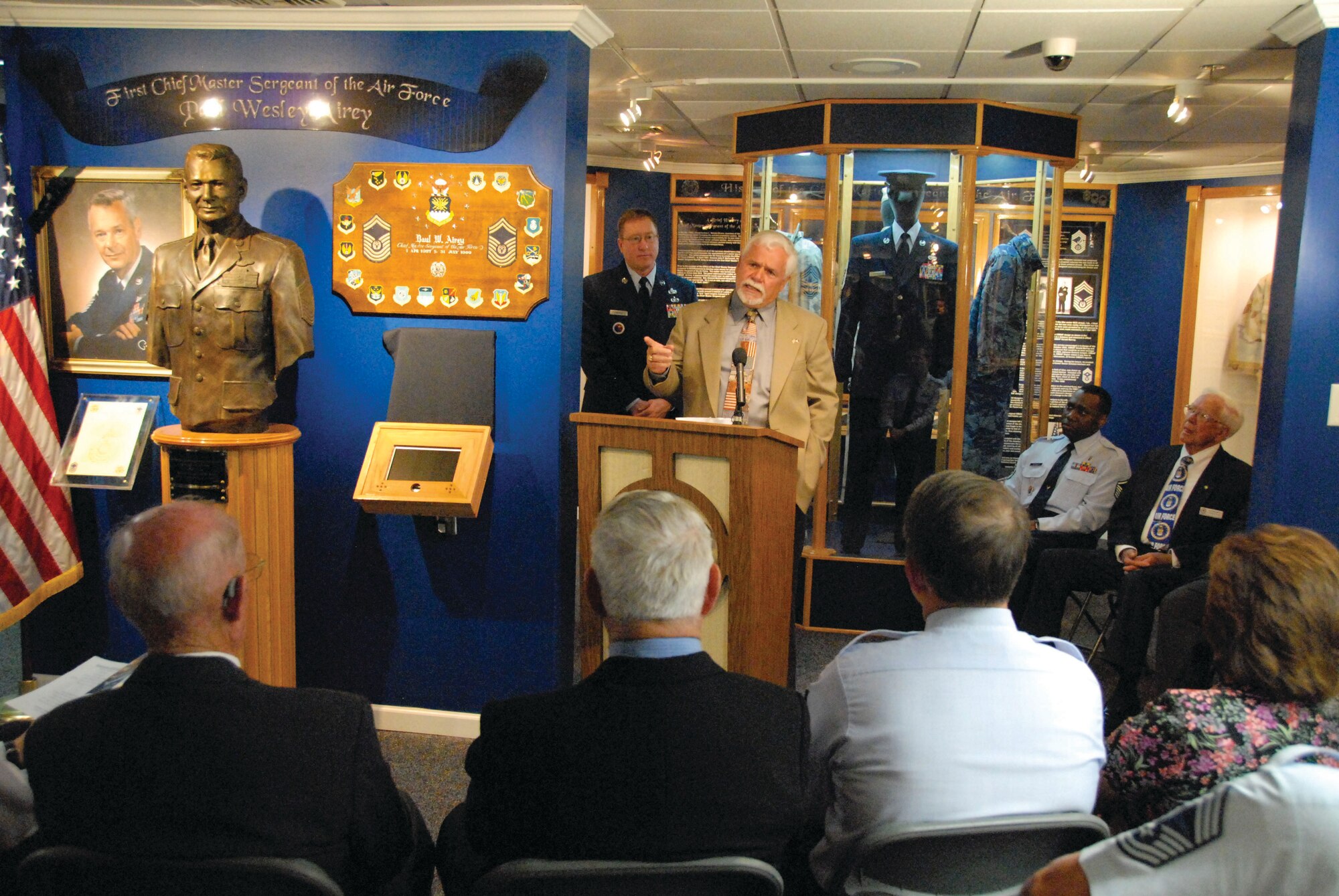 During the CMSAF #1 Ring Exhibit Dedication ceremony, Enlisted Heritage Research Institute Director Chief Master Sgt. Rick Fanning listens as Chief Airey’s son, retired Chief Master Sgt. Dale Airey, talks about life with his dad.  The dedication ceremony was held April 30 at Enlisted Heritage Hall. (U.S. Air Force photo by Jamie Pitcher)