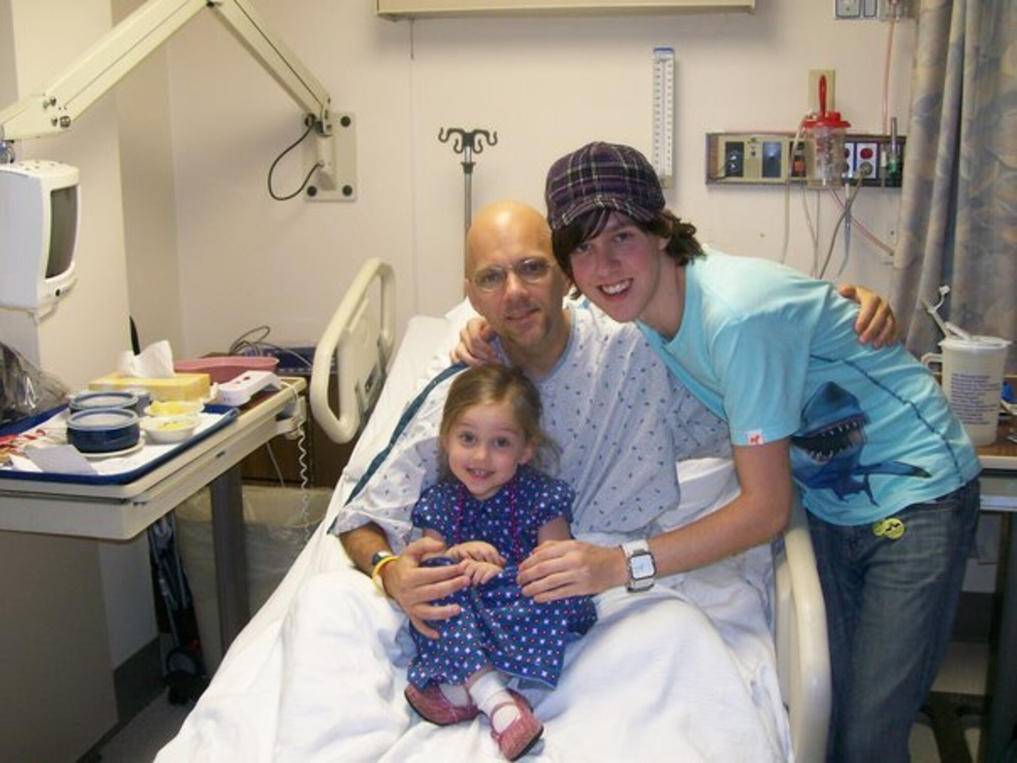 Master Sgt. Mike Sanders, pictured here with children Shawn and Jenna, before going into surgery to remove cancer from his neck and throat in 2007.  Sergeant Sanders had lost some of his epiglottis, part of the right pharyngeal wall, and a neck muscle along with over 40 lymph nodes.  Eating was impossible right away.  It was done through a feeding tube direct to his stomach.  (Photo courtesy Master Sgt. Mike Sanders) 