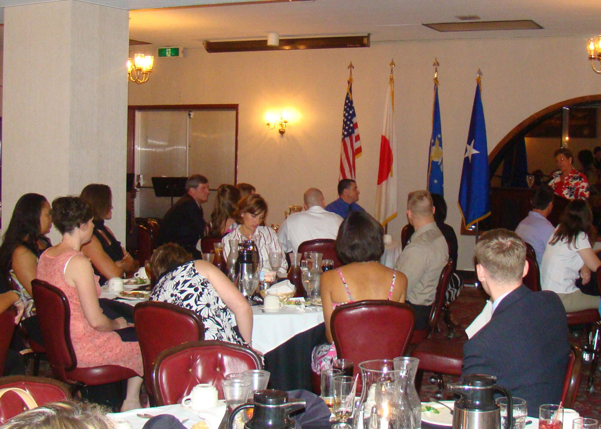 KADENA AIR BASE, Japan -- Attendees of the 353rd Special Operations Group "Evening of Appreciation" listen to Marianne Williams, the wife of Brig. Gen. Brett Williams, the 18th Wing commander, speak at the Kadena Officers' Club here May 9. More than 50 members of the group gathered to celebrate and honor military spouses for their daily contributions and selfless sacrifice supporting the military members. The event featured live music, guest speakers, dinner and dancing. (Courtesy photo) 