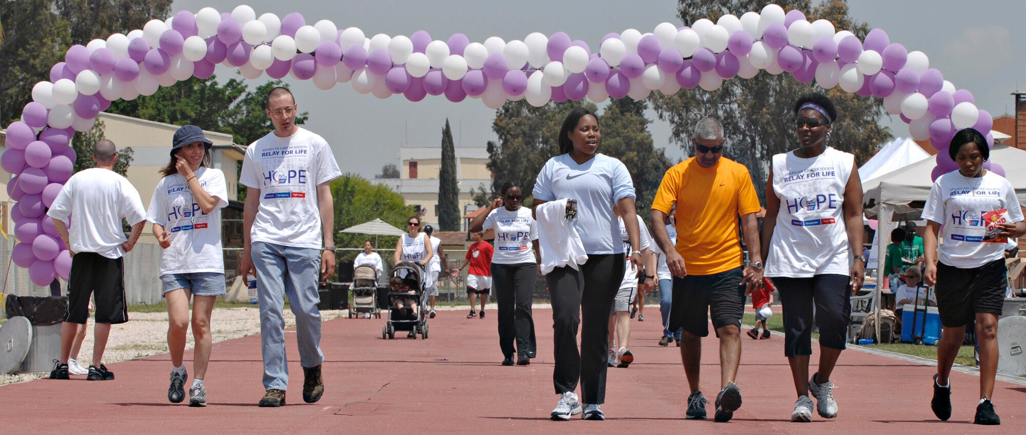 Participants in the Relay for Life walk laps around the Incirlik running track, May 9, 2009. The 2009 Relay for Life was the first relay available to members of the Incirlik community and hosted more than 300 participants from 20 teams, raising more than $9,500. The event lasted 12 hours and included a luminaria ceremony in which participants wrote the names of cancer survivors and victims on more than 100 luminary bags. (U.S. Air Force photo/Senior Airman Benjamin Wilson)