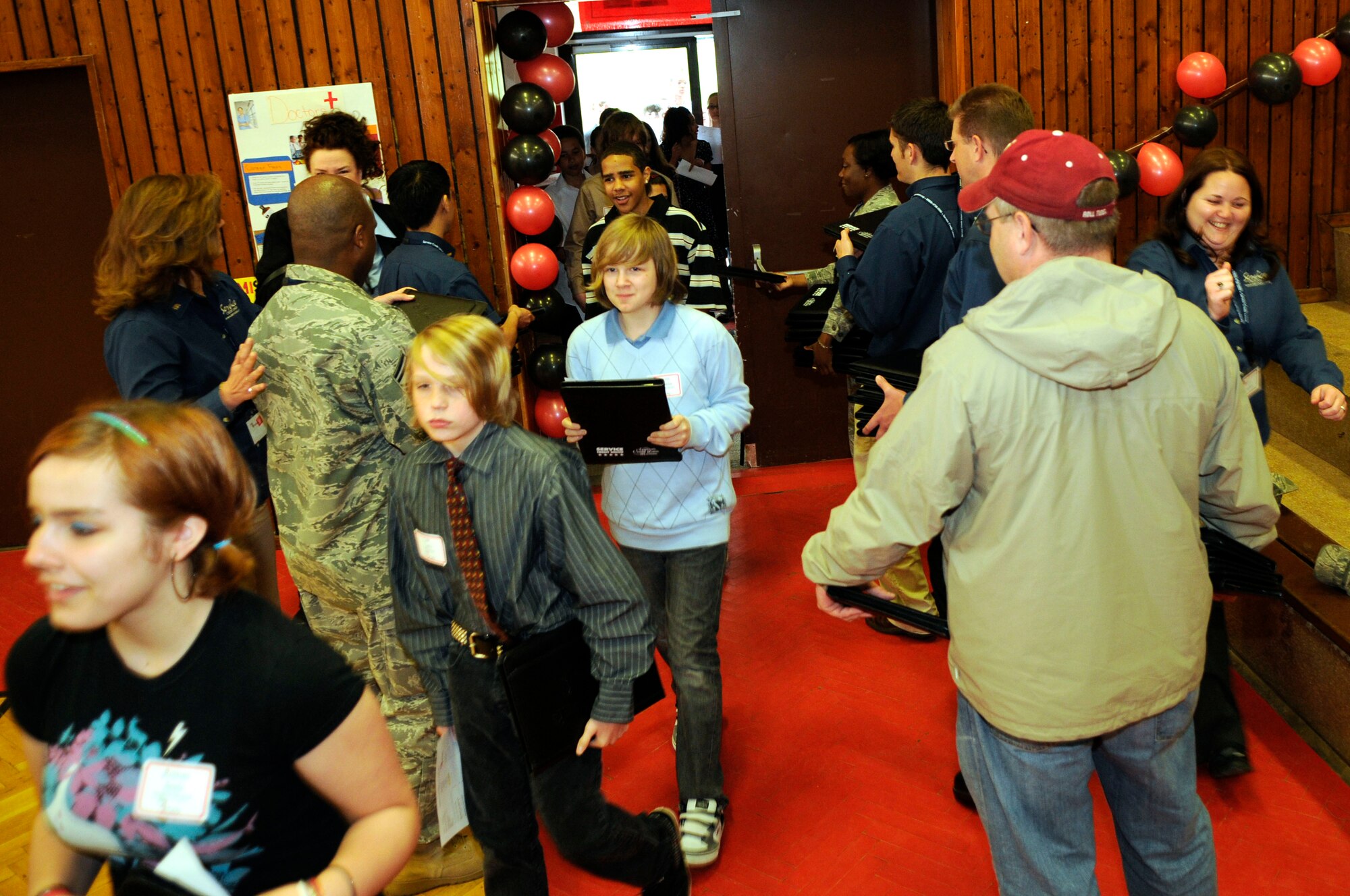 Kaiserslautern Middle School seventh graders receive their budgeting and planning files before entering the school's gymnasium, Vogelweh Military Complex, Germany, April 30, 2009. Students participated in the CU 4 Reality Fair which taught them how to manage finances. (U.S. Air Force photo by Senior Airman Amanda Dick)(Released)