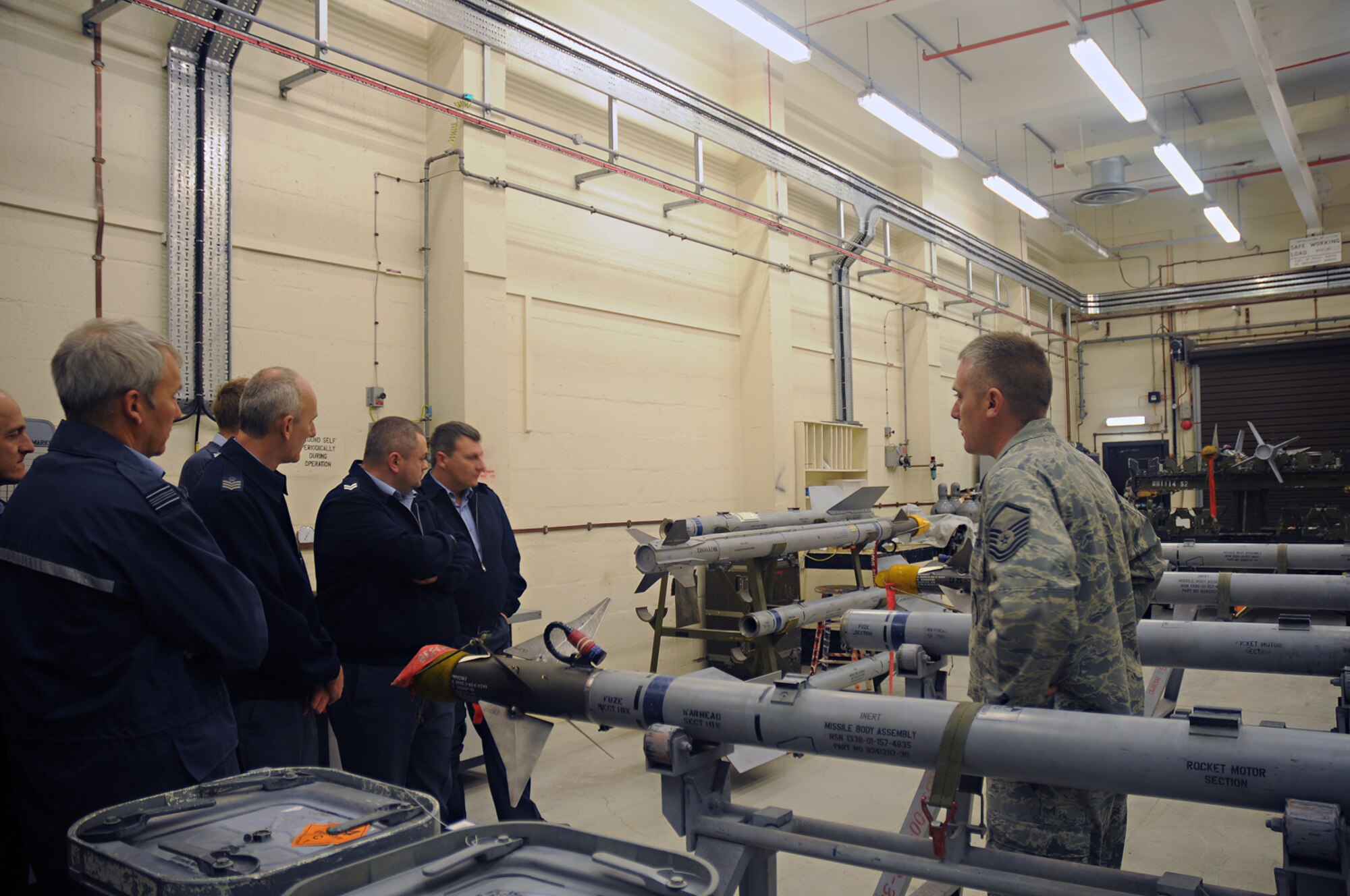 ROYAL AIR FORCE LAKENHEATH, England – Master Sgt. Jeff Rogers, 48th Munitions Squadron explains the 48th MUNS processes and procedures for constructing an AIM-9 missile to British Airmen from the 93rd Expeditionary Armament Squadron, RAF Marham May 8, 2009. The Airmen from RAF Marham are visiting the 48th MUNS for the first time as part of an exchange program designed to increase cooperation and interoperability between British and American forces. (U.S. Air Force photo by Senior Airman Kristopher Levasseur)