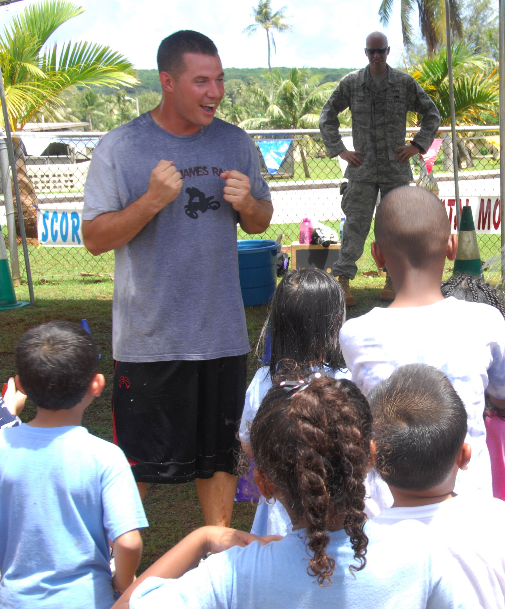 ANDERSEN AIR FORCE BASE, Guam - Senior Airman David Demarest, 36th Mobility Response Squadron crew chief, explains the object of the relay race station to Andersen Elementary School students during Fun and Fitness Week May 8. Fun and Fitness Week is an annual event held to promote being physically active. (U.S. Air Force photo by Senior Airman Shane Dunaway)
