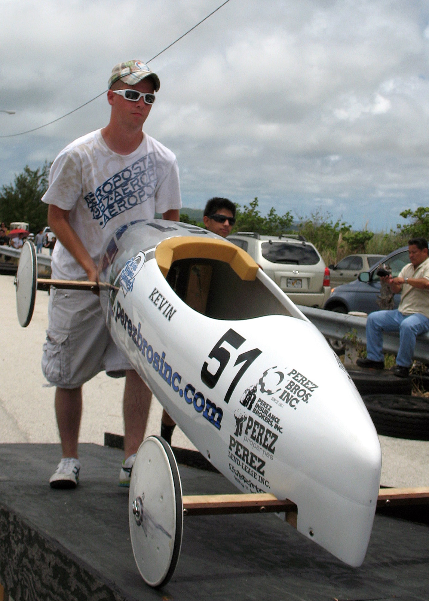 ANDERSEN AIR FORCE BASE, Guam -- Airman 1st Class Daniel Mckissack, 36th Maintenance Squadron aerospace ground equipment technician, help load a soap box car onto release ramp at the Yigo drag strip May 9. Approximately 20 Team Andersen volunteers were at the soap box derby. (U.S. Air Force photo by Airman Carissa Wolff)
