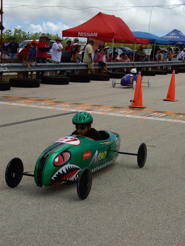 ANDERSEN AIR FORCE BASE, Guam -- The No. 27 Maxon soap box car races by the
Big Brother, Big Sister-sponsored car during the first round of races of the annual soap box derby held May 9 at the Yigo drag strip. (U.S. Air Force photo by Airman Carissa Wolff)
