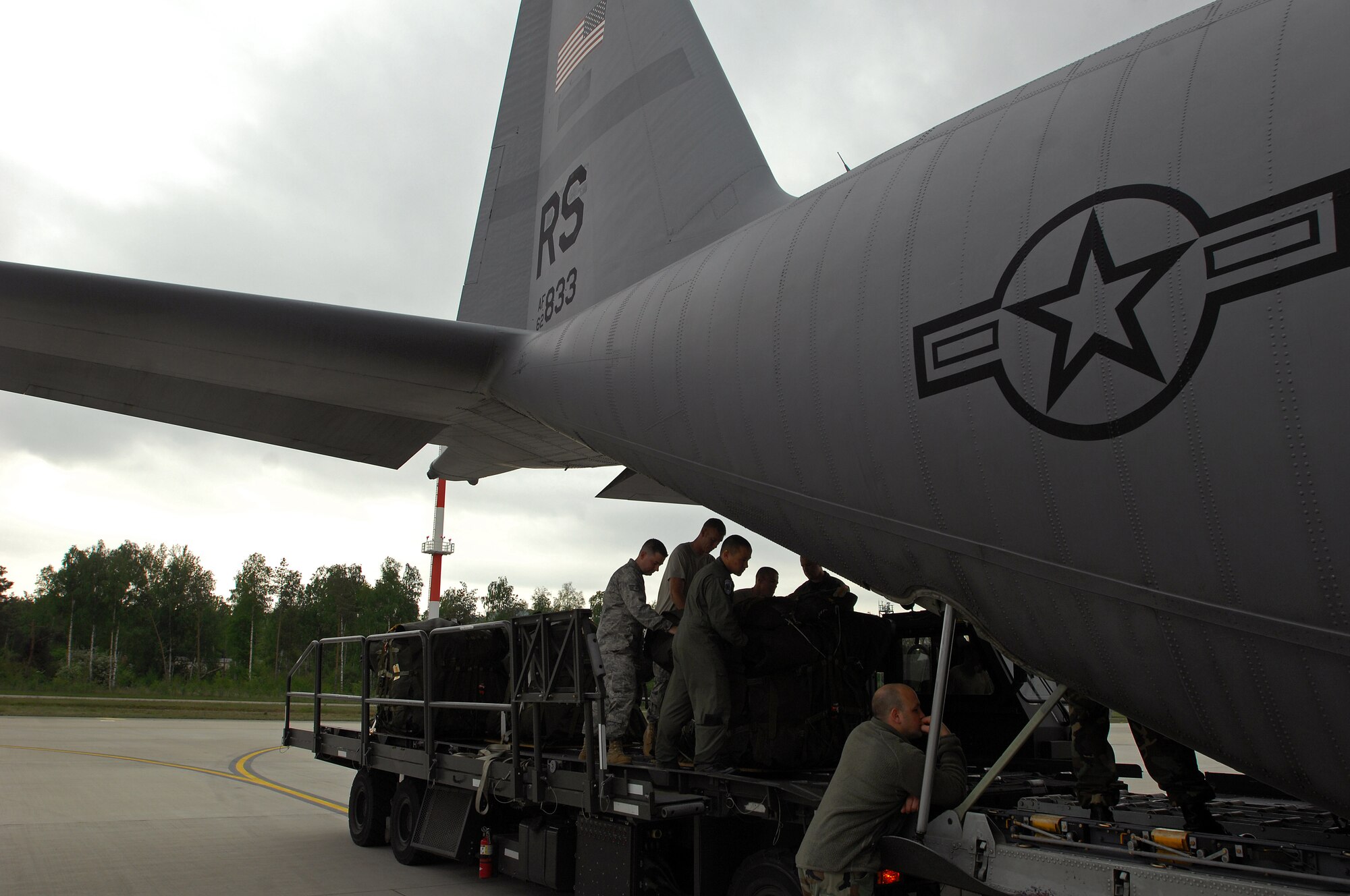 United States Air Force members with the 1st Combat Communication Squadron and 37th Airlift Squadron prepare to load life saving equipment onto a Ramstein C-130 Hercules, May 9, 2009, in support of NASA, in its launch of the space shuttle Atlantis scheduled for May 11, 2009. (U.S. Air Force photo by Senior Airman Kenny Holston)