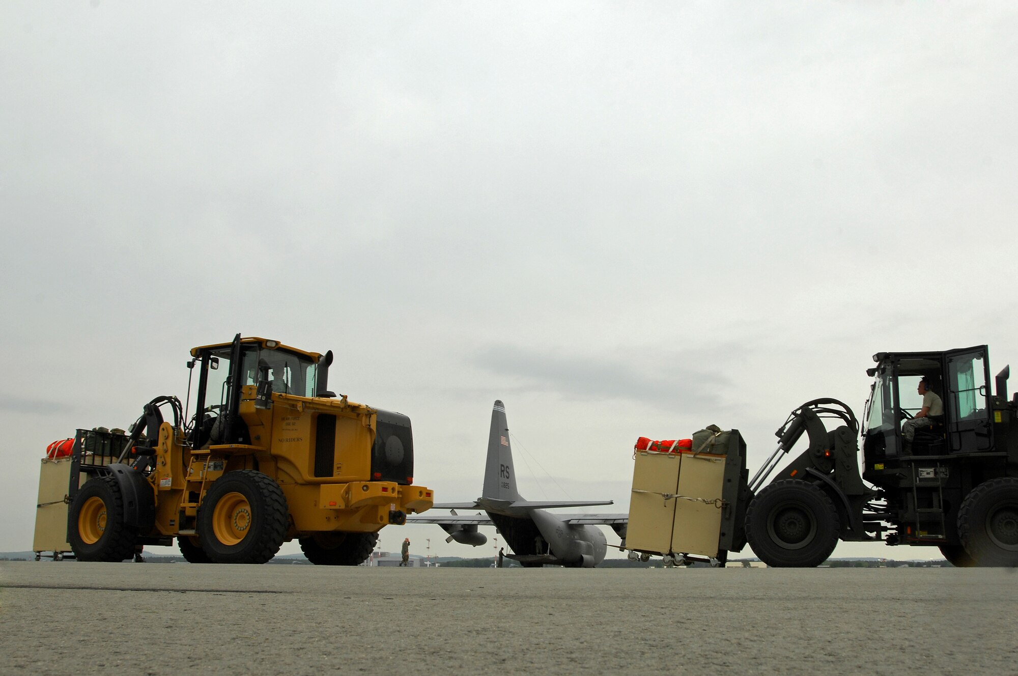 United States Air Force members with the 1st Combat Communication Squadron prepare to load life saving equipment onto a Ramstein C-130 Hercules, May 9, 2009, in support of NASA, in its launch of the space shuttle Atlantis scheduled for May 11, 2009. (U.S. Air Force photo by Senior Airman Kenny Holston)