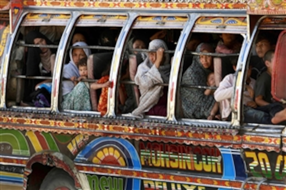 Pakistani residents flee the fighting between Pakistani soldiers and the Taliban sit on a decorated carrier outside Torkham, a border town at the Khyber Pass between Afghanistan and Pakistan, where U.S. Army soldiers and Afghan National Army Commandos checked vehicles, April 29,2009. Torkham is the busiest port of entry between the two countries. The U.S. soldiers are assigned to the 2nd Battalion,19th Special Forces Group.