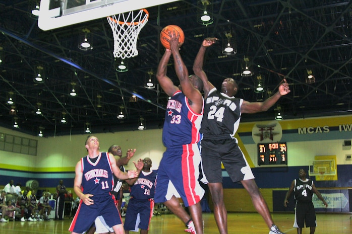 Untouchables center Mario Brown goes up strong to the hoop as Hand Selected  forward Charles Williams tries to block Brown’s shot. The Untouchables trailed by as much as nine points during the first half of play but took the lead during the closing minutes and never let it go throughout the rest of the game.