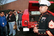 Gunnery Sgt. Miguel Cruz, a canvassing recruiter at Recruiting Substation Chicago Lawn, Marine Corps Recruiting Station Chicago, addresses high school students during a static display at Marie Curie High School May 11 as part of the inaugural Marine Week Chicago. The static display at Chicago's second largest high school was one of the first events of the inaugural Marine Week Chicago. Marine Week Chicago, which runs from May 11-17, is an opportunity for Chicago citizens to meet the men and women of the Marine Corps and learn about its history, traditions and value to the nation.