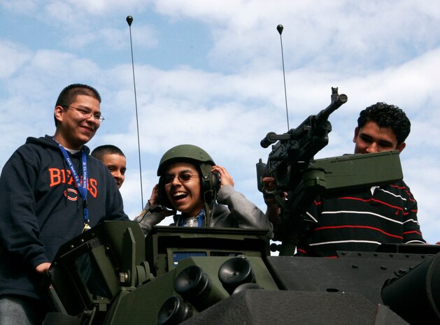 Marie Curie High School students get a taste of what its like in the turret of a light armored vehicle during a static display at Marie Curie High School May 11 as part of the inaugural Marine Week Chicago.  The static display at Chicago's second largest high school was one of the first events of the inaugural Marine Week Chicago. Marine Week Chicago, which runs from May 11-17, is an opportunity for Chicago citizens to meet the men and women of the Marine Corps and learn about its history, traditions and value to the nation.