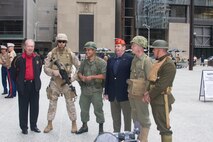Marines in historical uniforms pose for pictures during the Marine Week Dedication Ceremony.