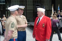 James Laskey, National Commandant for the Marine Corps League talks with Marines before the Marine Week Dedication Ceremony.