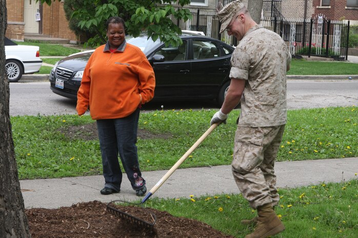 Lance Cpl. Timothy R. James, 2nd Battalion, 24th Marine Regiment, talks with Rhonda Harding, a local resident, while raking at Levin Park located in Chicago May 11, 2009. Marines are cleaning up parks as well as taking part in other community services and efforts as part of Marine Week being held in Chicago. (U.S. Marine Corps photo by Cpl. Seth Maggard/Released)