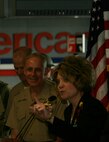 Linda P. Kozma, the administrative coordinator and chapter chairman for military veteran's resource group speaks during the dedication ceremony of an American Airlines gate honoring the United States Marine Corps during Marine Week.