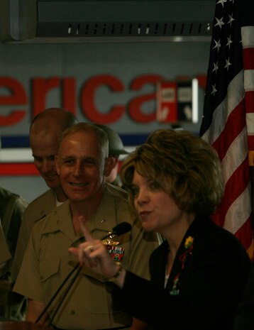 Linda P. Kozma, the administrative coordinator and chapter chairman for military veteran's resource group speaks during the dedication ceremony of an American Airlines gate honoring the United States Marine Corps during Marine Week.