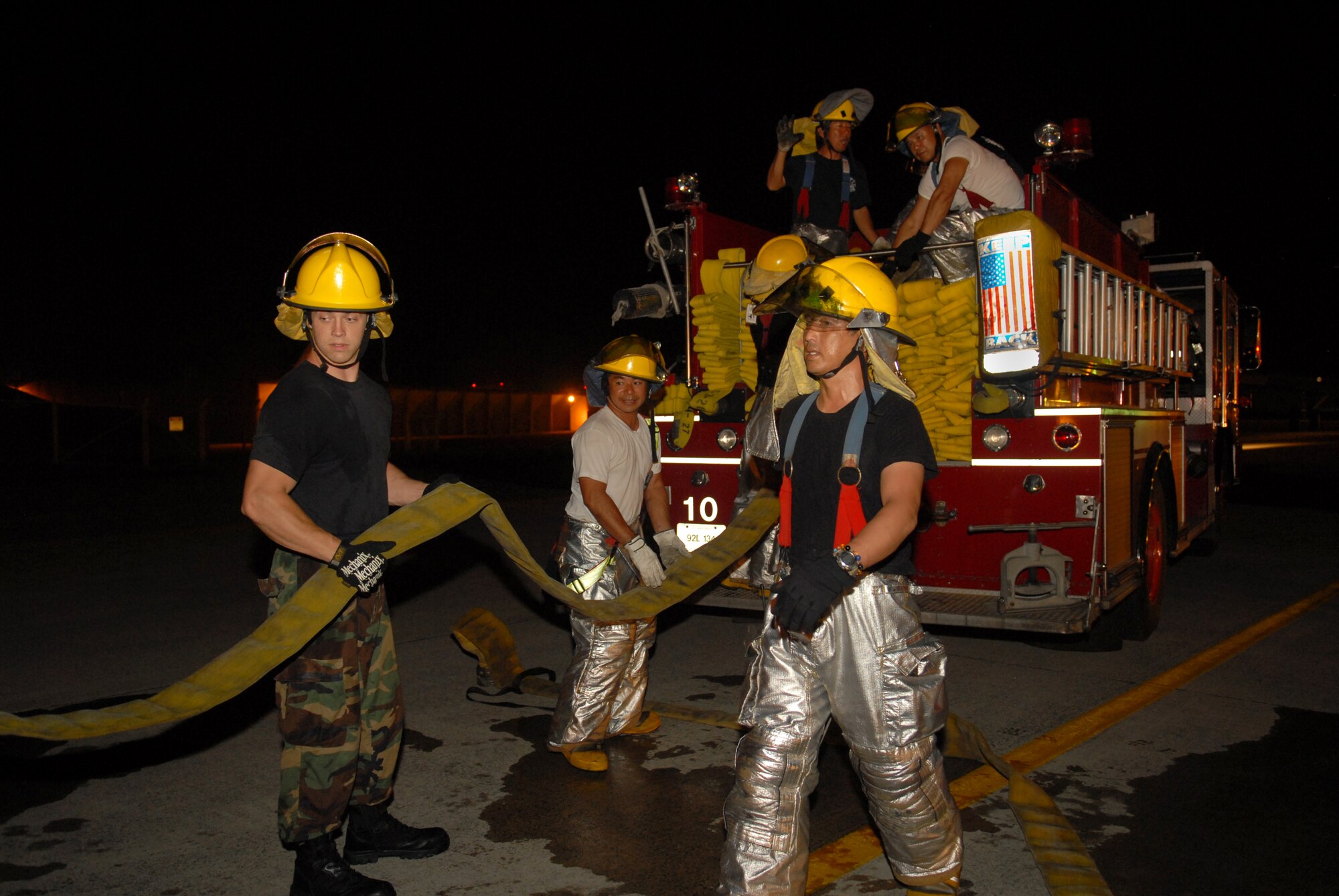 Kadena fire fighters roll up fire hoses after responding to a simulated aircraft emergency during the Beverly High 09-2 Local Operational Readiness Exercise at Kadena Air Base, May 12. The LORE tests base personnel on their combat readiness for real world emergency/combat events.
(U.S. Air Force photo/Tech. Sgt. Angelique Perez) 