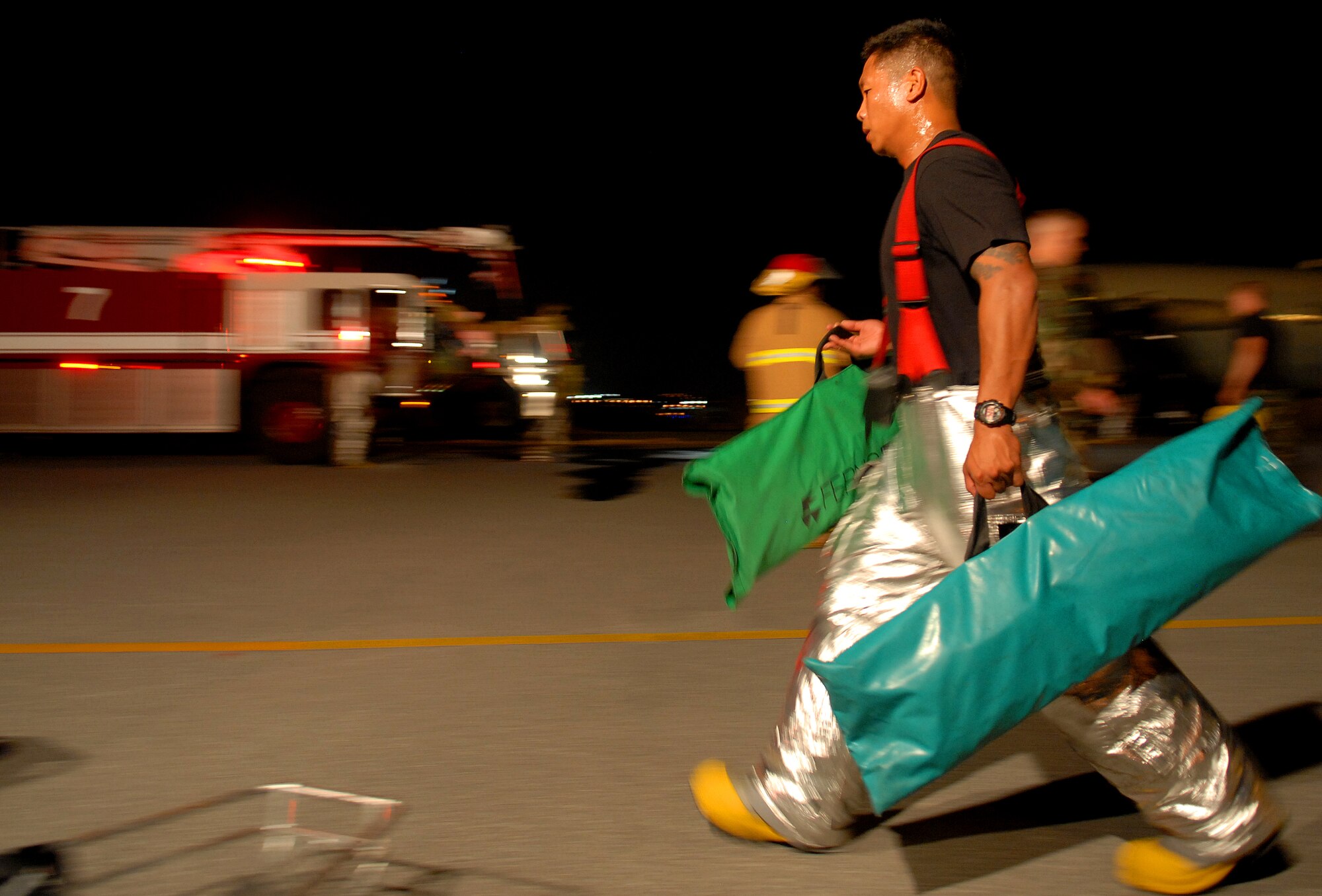 Kadena fire fighters respond to a simulated aircraft emergency during the Beverly High 09-2 Local Operational Readiness Exercise at Kadena Air Base, May 12. The LORE tests base personnel on their combat readiness for real world emergency/combat events.
(U.S. Air Force photo/Tech. Sgt. Angelique Perez) 
