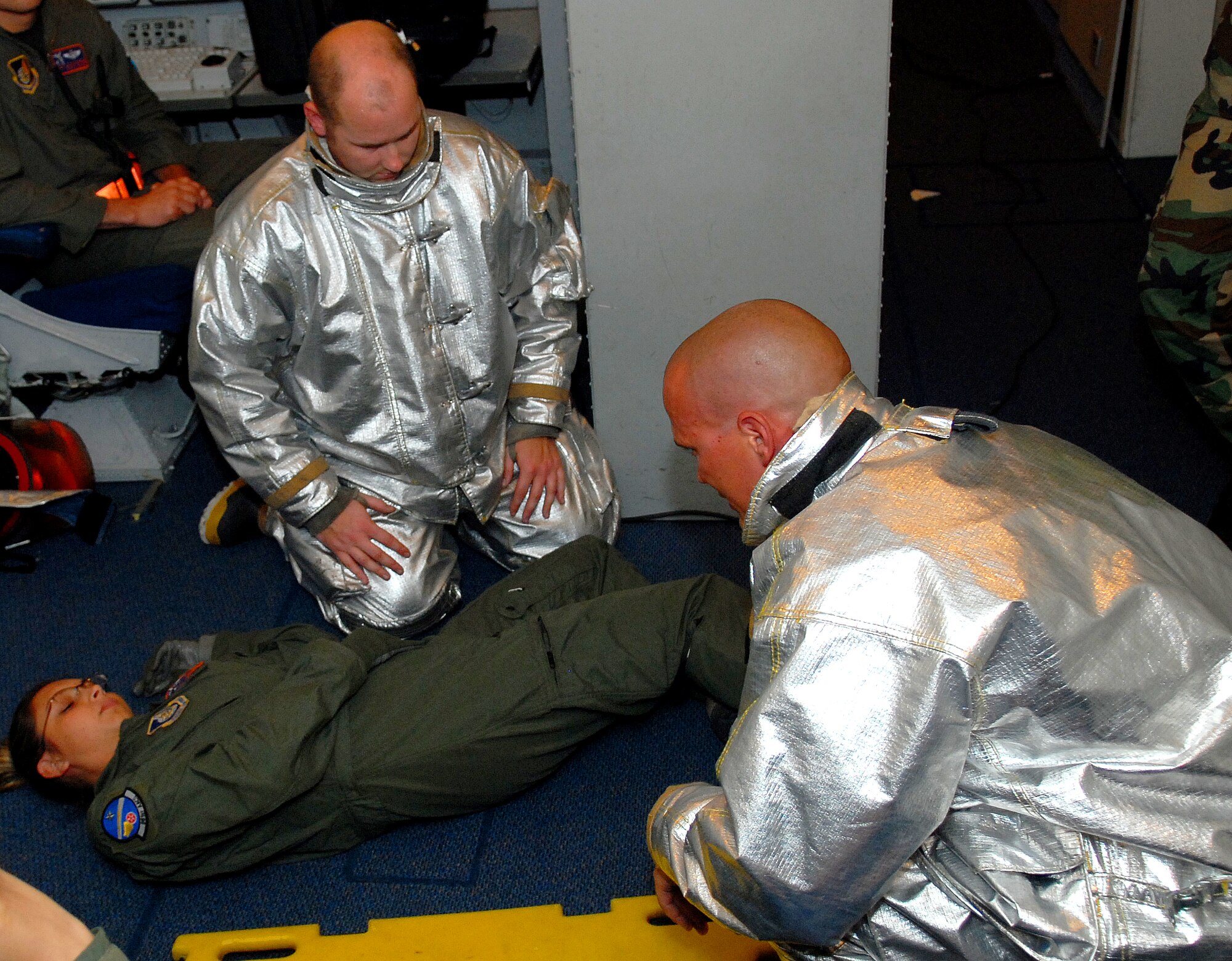 Kadena fire fighters place an injured person on a backboard for immobilization in response to a simulated aircraft emergency during the Beverly High 09-2 Local Operational Readiness Exercise at Kadena Air Base, May 12. The LORE tests base personnel on their combat readiness for real world emergency/combat events.
(U.S. Air Force photo/Tech. Sgt. Angelique Perez) 