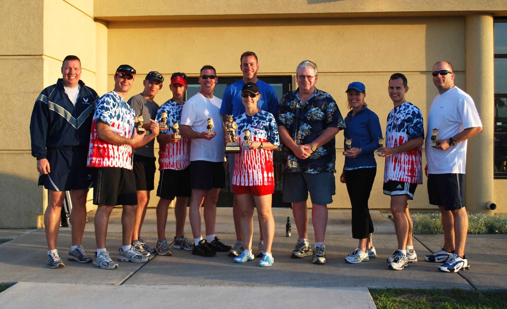 After receiving the award for the Most Money Raised by a Team, the 615th Contingency Response Wing Phoenix Mobility Team, who also organized the event, pose for a photo with Col. John Lipinski, 615th CRW commander (left) and Rick Writer, Eagle Eye Engraving, who sponsored all of the trophies, t-shirts and water bottles for participants.  Viking Challenge, an annual 12-hour relay event, is the Travis Fisher House’s largest fundraiser each year.  (U.S. Air Force photo/1st Lt. Nicole Langley)