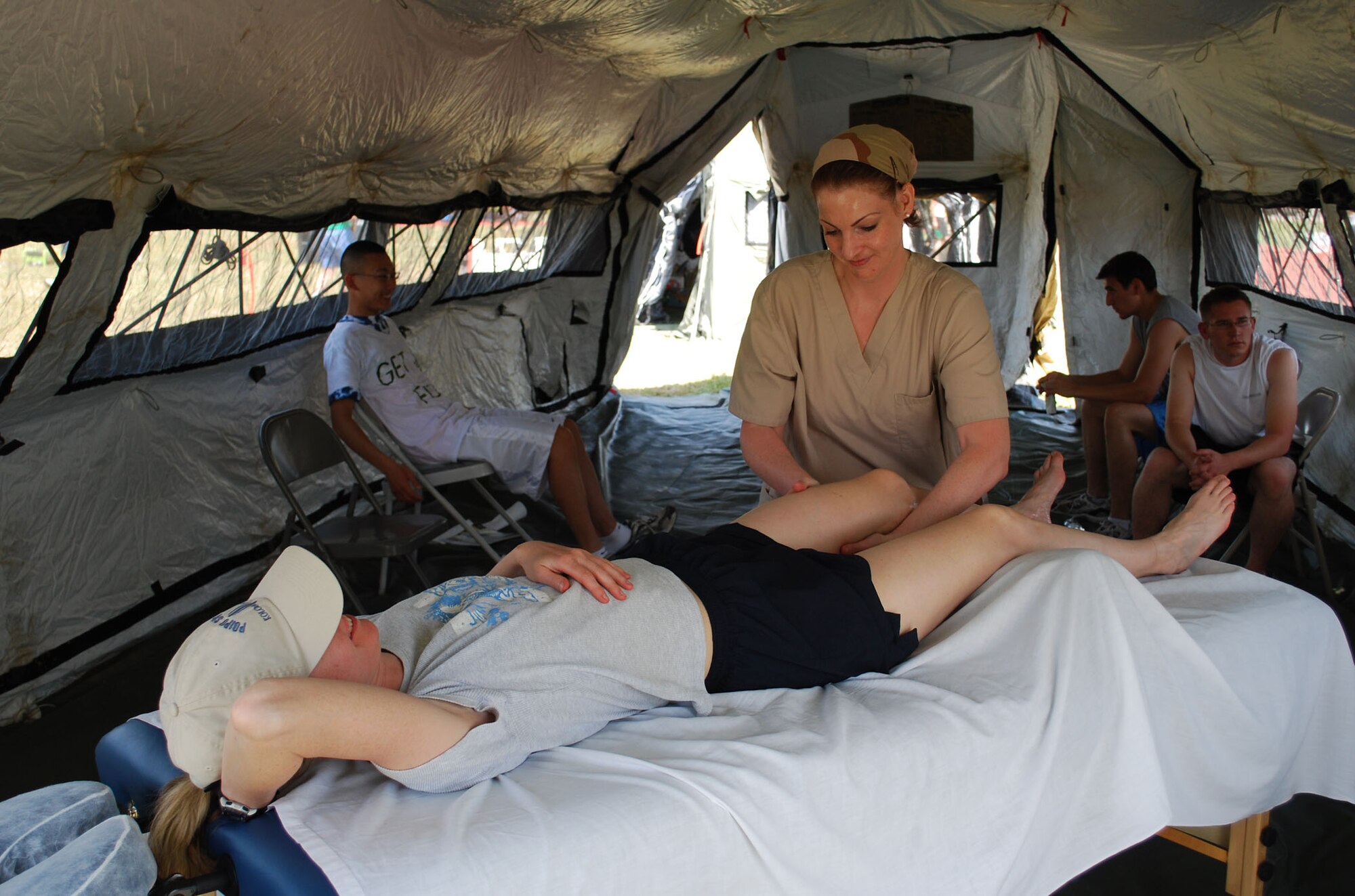 Meredith Mingledorff, Travis Air Force Base Liaison for Travis Credit Union and certified massage therapist, provides a sports massage for a participant during Viking Challenge May 9 at the Travis AFB track.  Ms. Mingledorff worked throughout the entire 12-hour period and provided free massages for approximately 60 participants.  The 60th Medical Operations Squadron’s Physical Medicine Element also provided free massages and stretching throughout the day. (U.S. Air Force photo/1st Lt. Nicole Langley)
