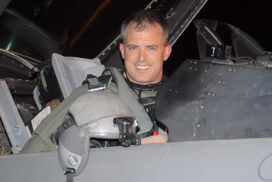 Major Brian Turner, 120th Fighter Squadron pilot smiles for the camera before lowering the canopy of his F-16 fighter jet and starting the engine.