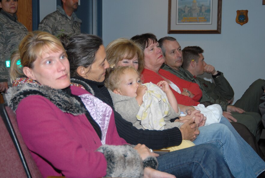 140th Wing members listened to the preflight briefing prior to take off.  (Left to right, Emily Conklin, Lisa Wolf and daughter Stella, Cheryl Dunstan, along with the Adjutant General, Colorado Air National Guard, Maj. Gen. H. Michael Edwards and his wife Laury and son James.  Approximately 15 aircraft left early Tuesday morning for a three month deployment to Iraq.